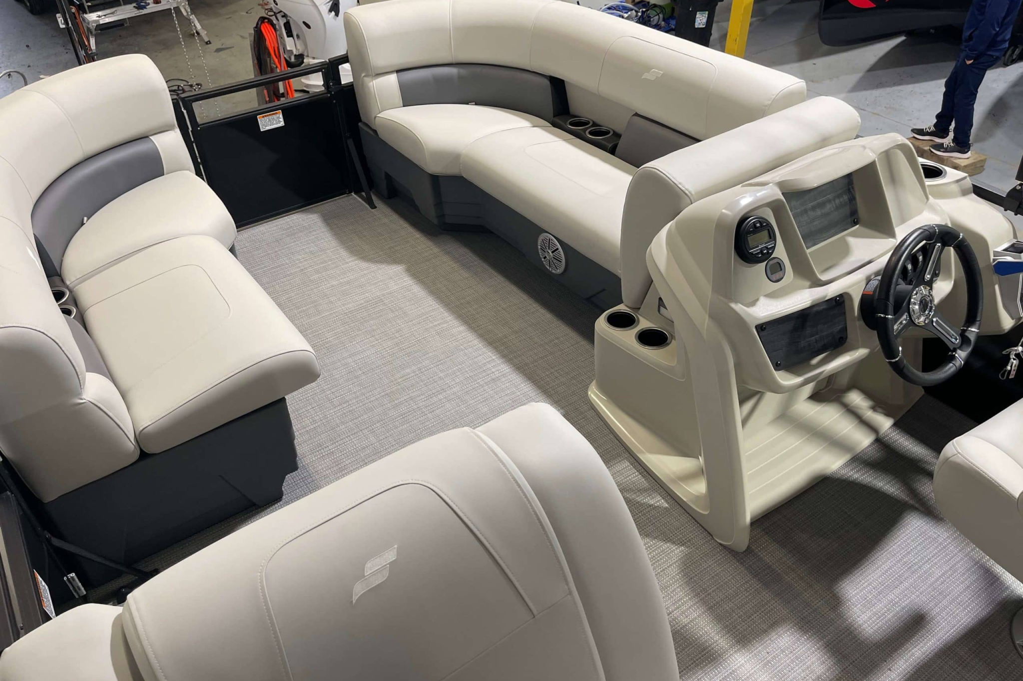 The interior layout of the 2024 WX Tritoon WX-003, featuring wraparound seating, helm console, cup holders, and open deck space designed for comfort and social cruising.