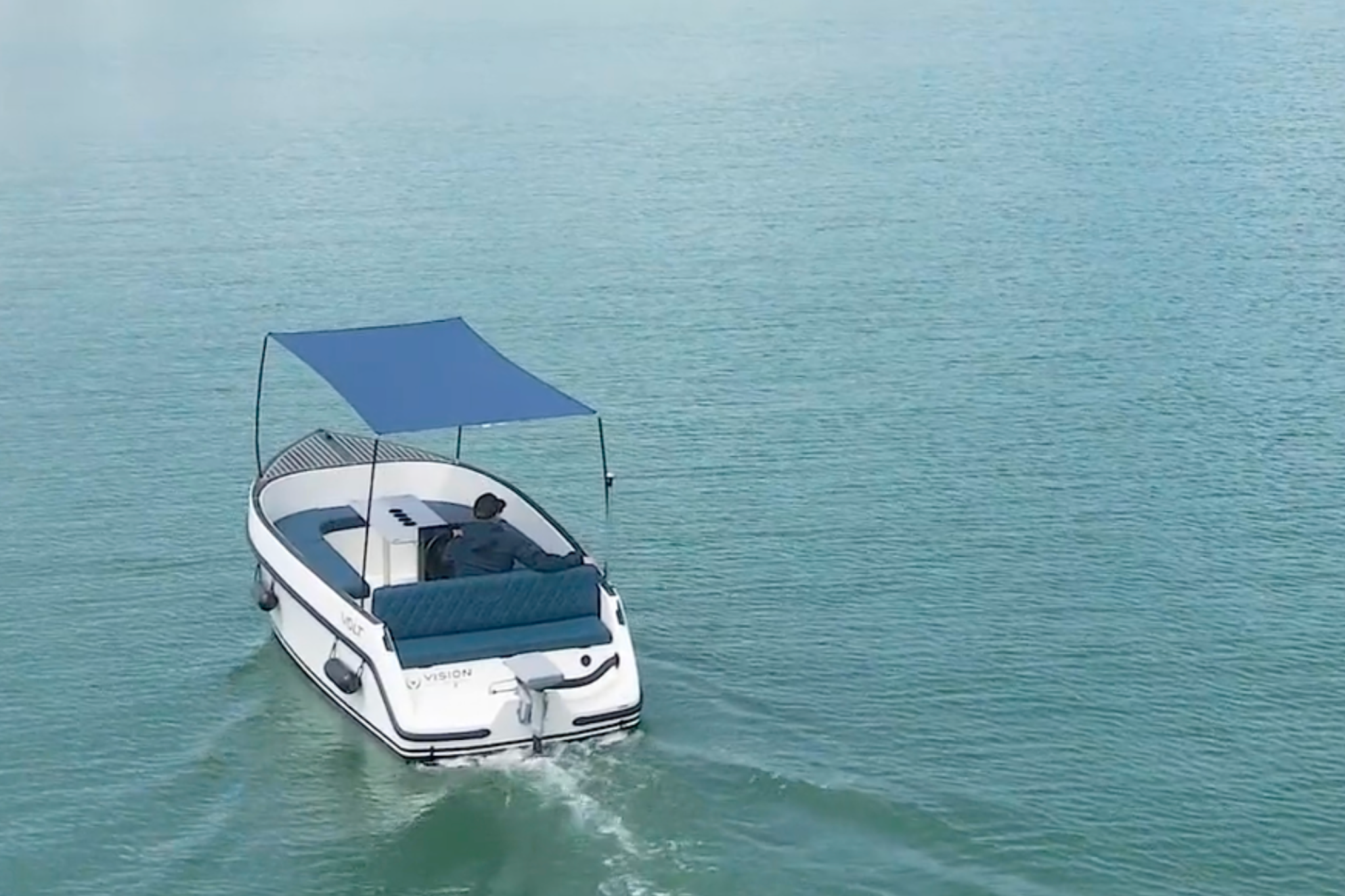 The 2025 Volt 180 operating near shore with its electric outboard visible, representing the value-focused pricing and low-maintenance appeal of this electric boat.