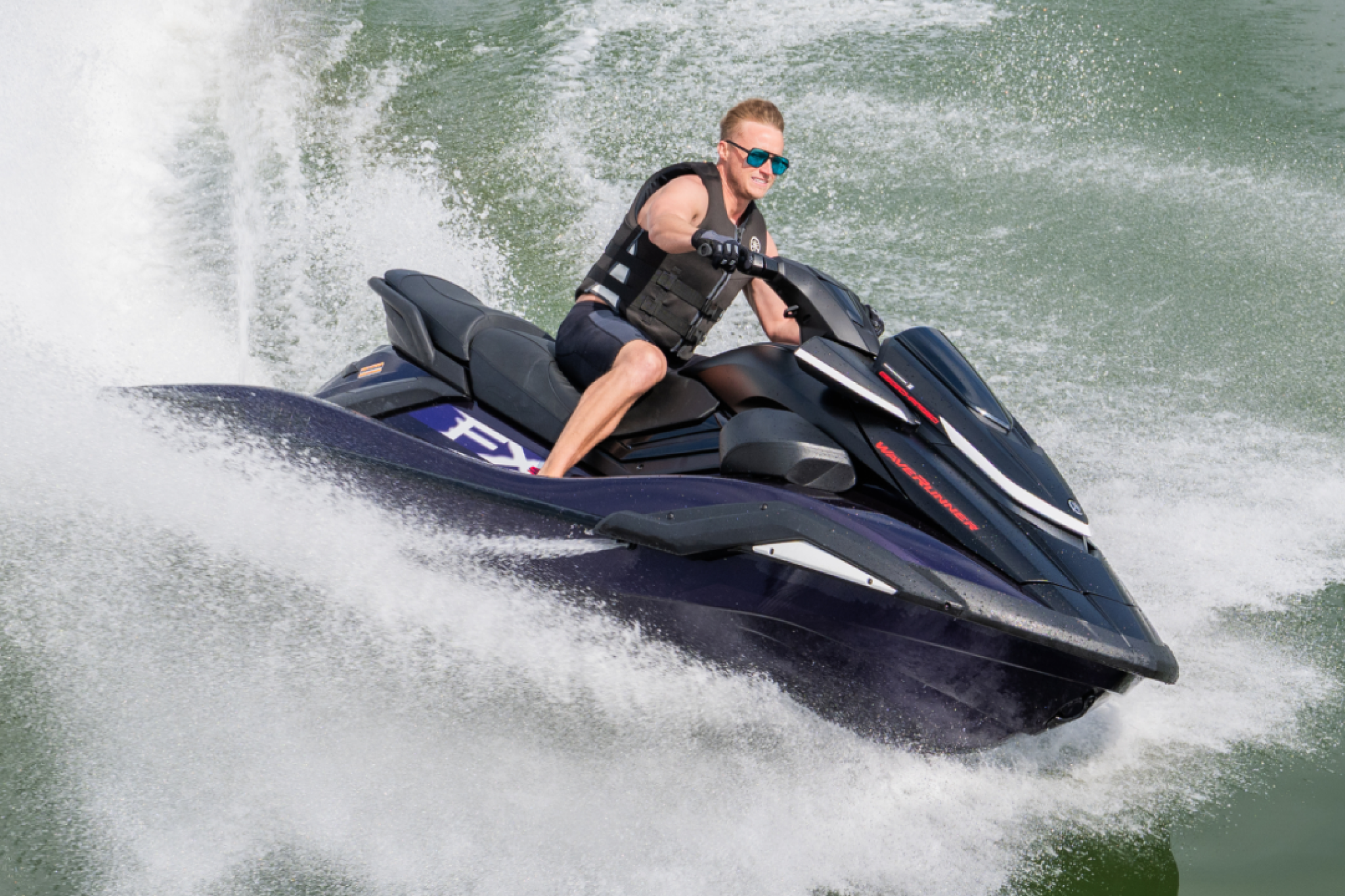 Rider carving hard turns on the 2026 Yamaha FX SVHO, demonstrating responsive steering, strong acceleration, and controlled high-speed performance.