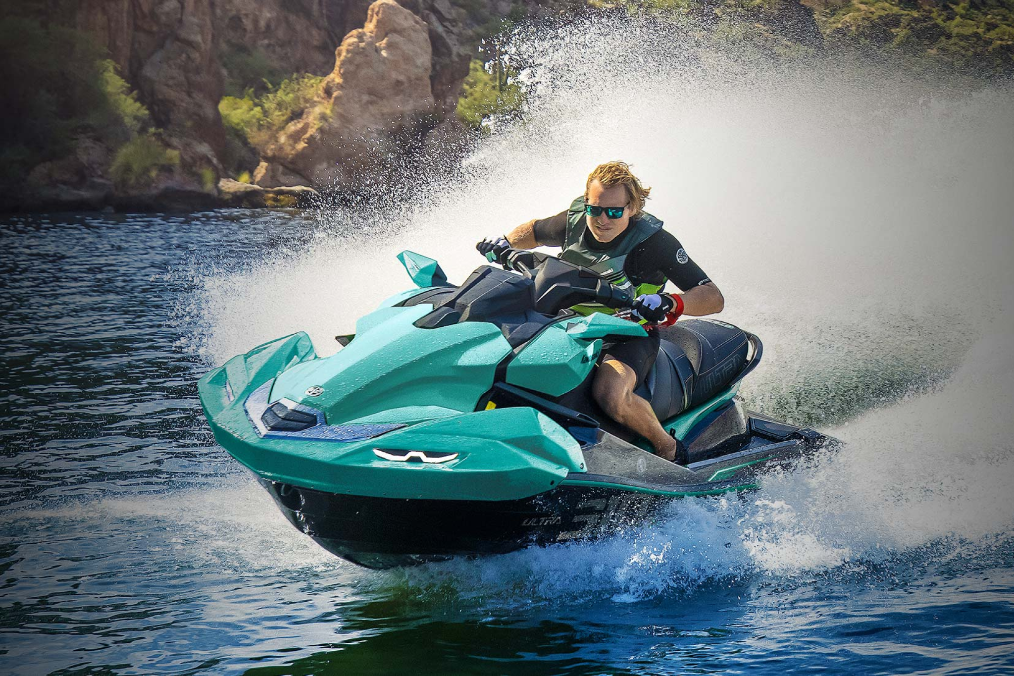 Rider pushing the 2026 Kawasaki Jet Ski Ultra 310LX-S through a fast turn, highlighting its supercharged power, aggressive handling, and full-size stability.