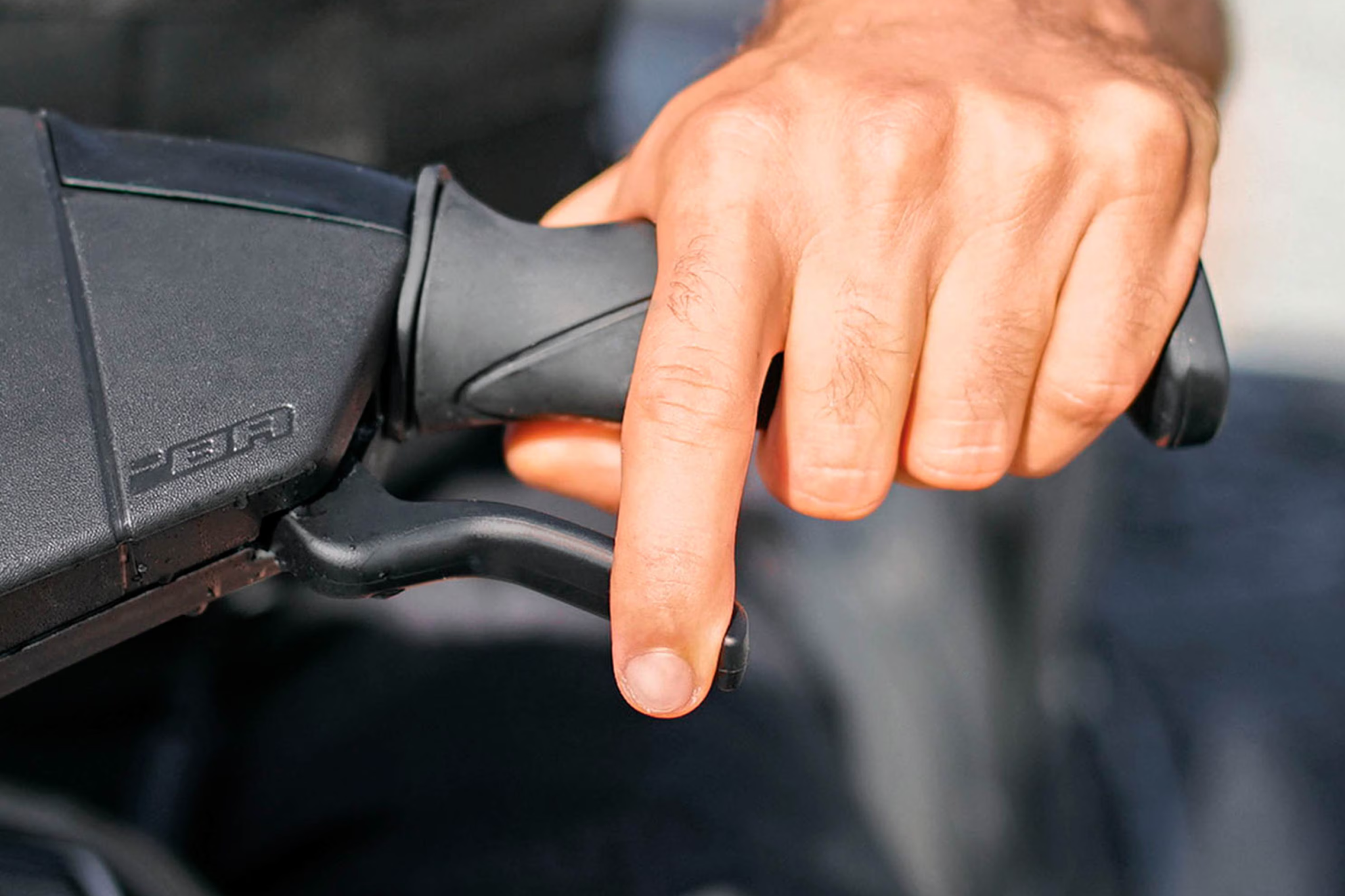 Close-up of the iBR brake lever on the 2026 Sea-Doo GTI, showing the Intelligent Brake and Reverse system for controlled stopping and docking.