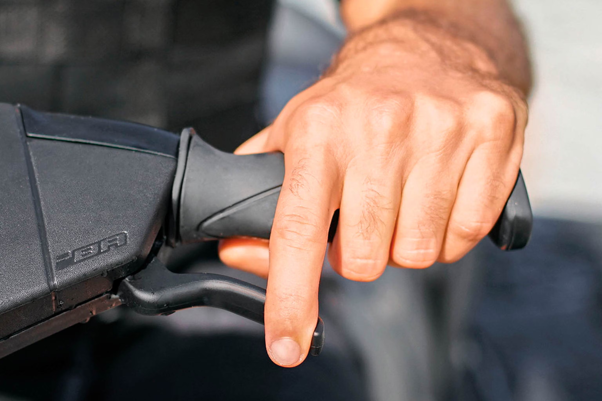 Detail view of the handlebar controls on the 2026 Sea-Doo Spark, featuring the iBR brake lever for improved low-speed control and docking.