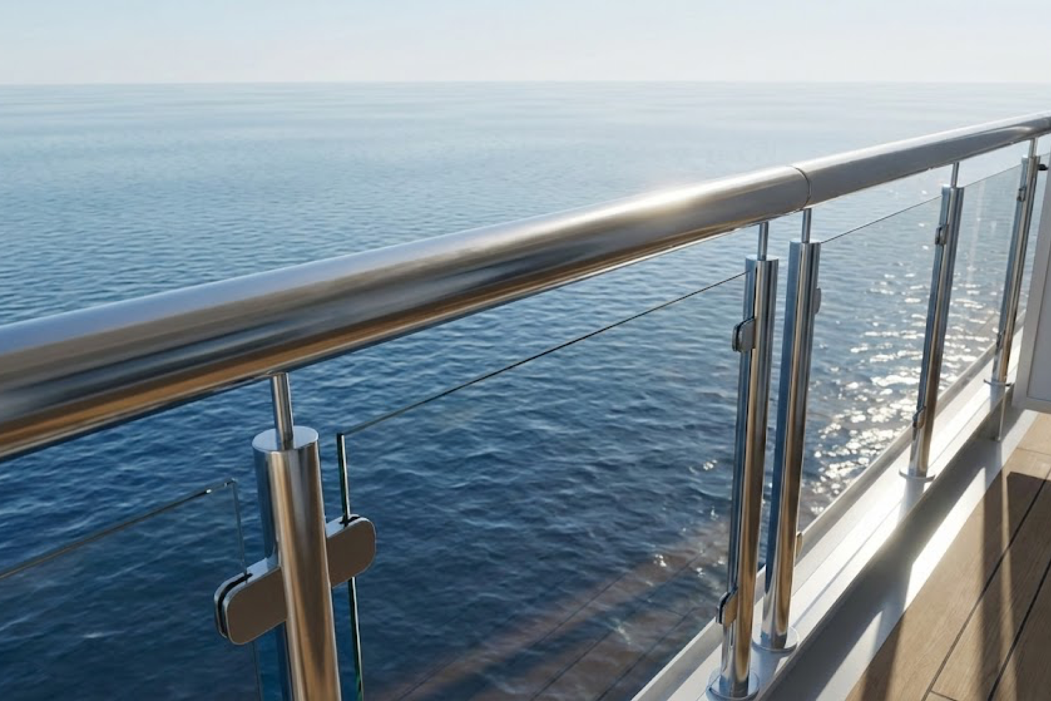 A close view of a cruise ship balcony railing over open water, showing things you should never do in your cruise cabin, such as leaning or sitting on railings.