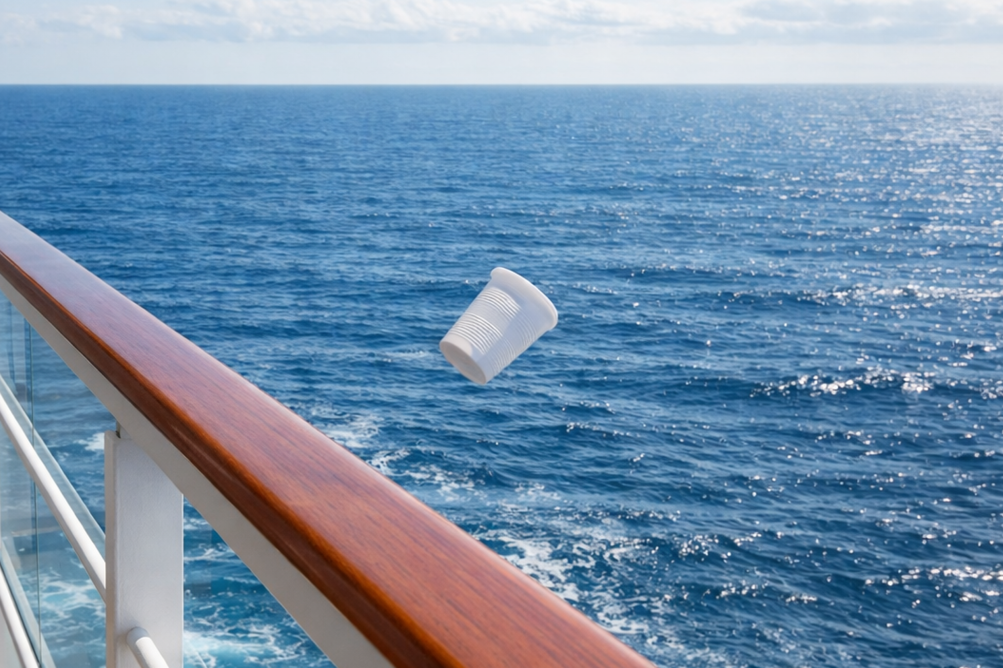 An object being thrown from a cruise ship balcony into the ocean, representing things you should never do in your cruise cabin under maritime and environmental laws.