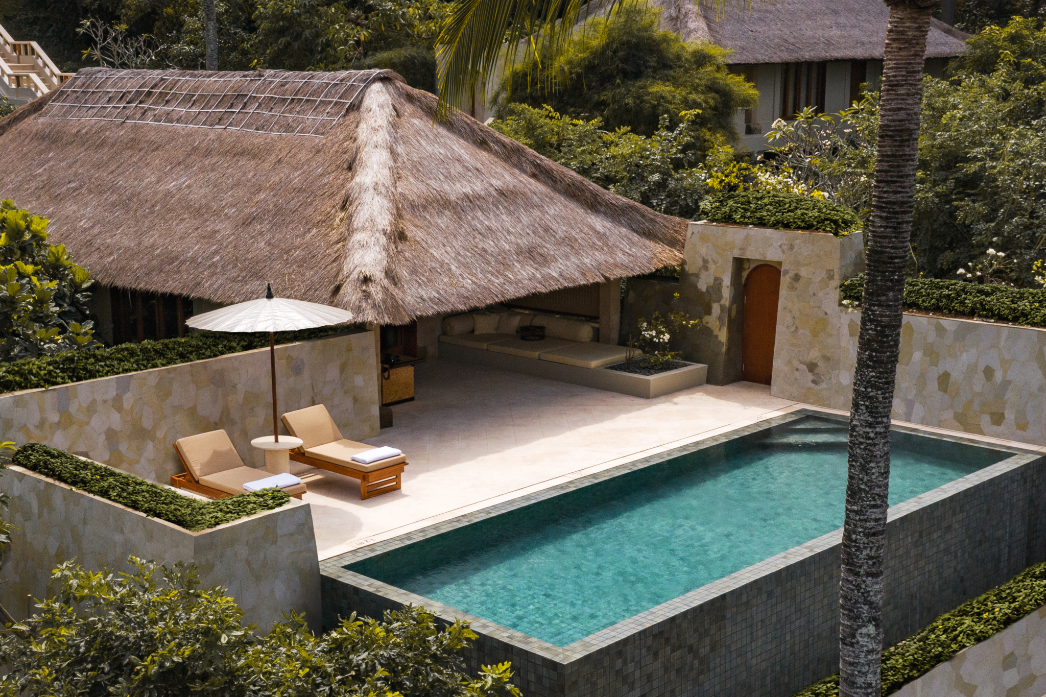 Private suite with plunge pool and thatched roof at Amankila, designed for seclusion and calm