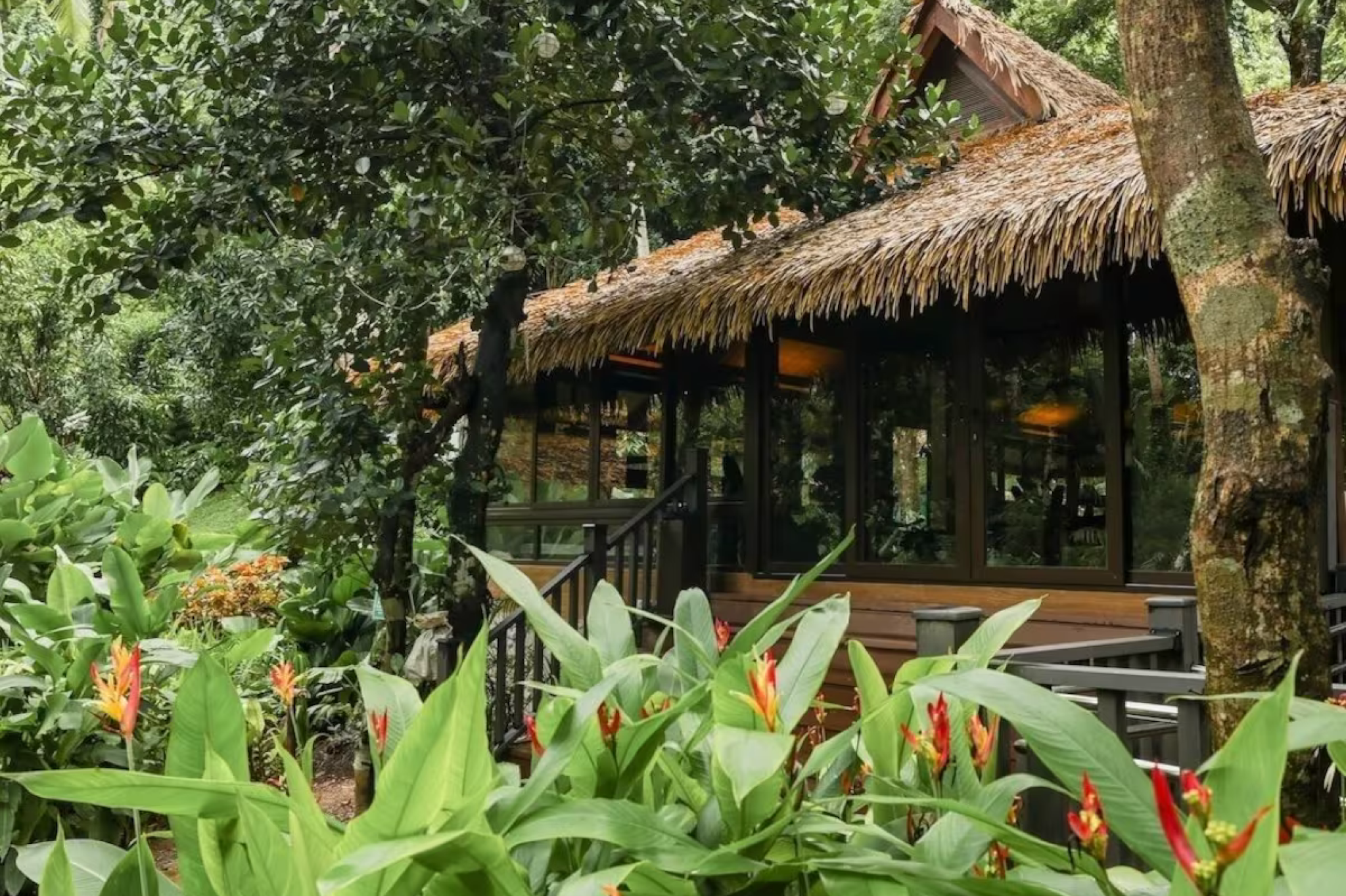 Jungle-clad villa at Lihim Resorts in El Nido Palawan, surrounded by lush foliage and vibrant tropical plants — a hidden gem among the best beach resorts in El Nido Palawan for privacy and wellness.