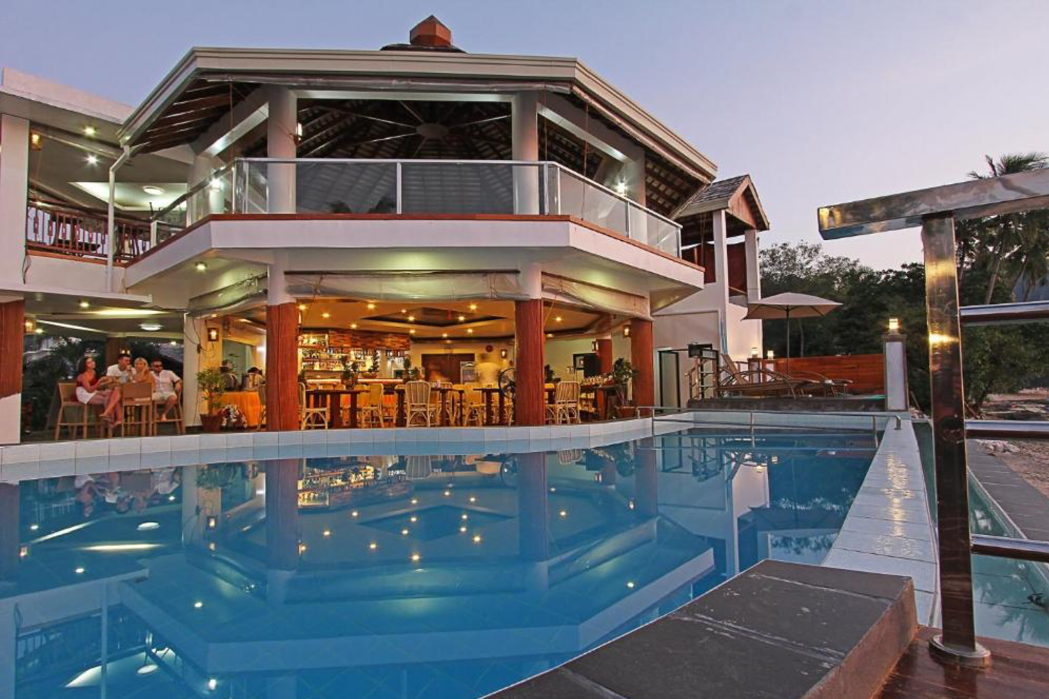 Poolside bar and open-air dining area at The Nest El Nido Beach Resort, with modern architecture and ocean-facing design — one of the best beach resorts in El Nido Palawan offering comfort near town.