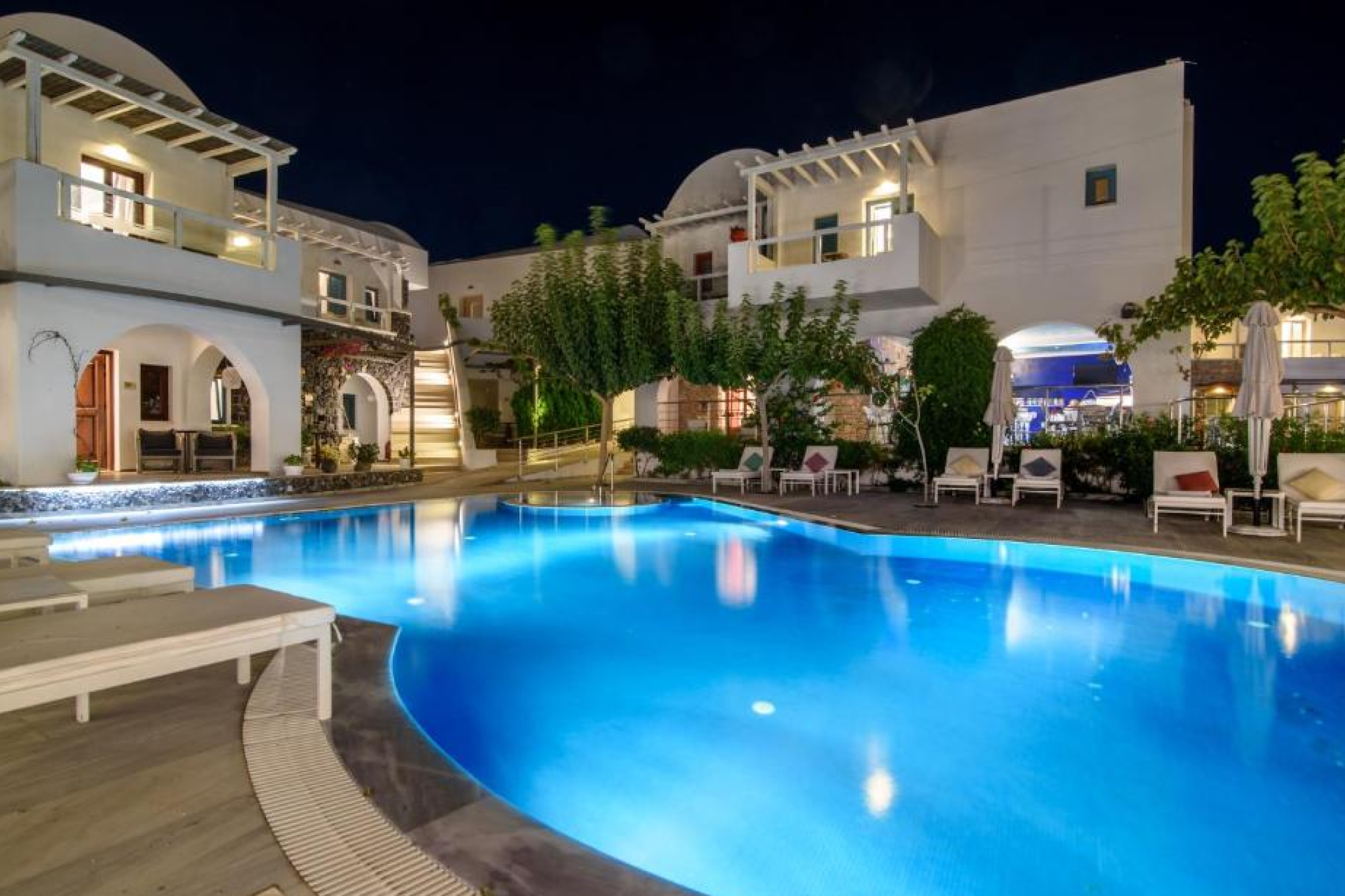 Elegant pool and courtyard at La Mer Deluxe Hotel & Spa, a boutique property listed among the Best Beach Resorts in Santorini, blending refined interiors with seaside charm