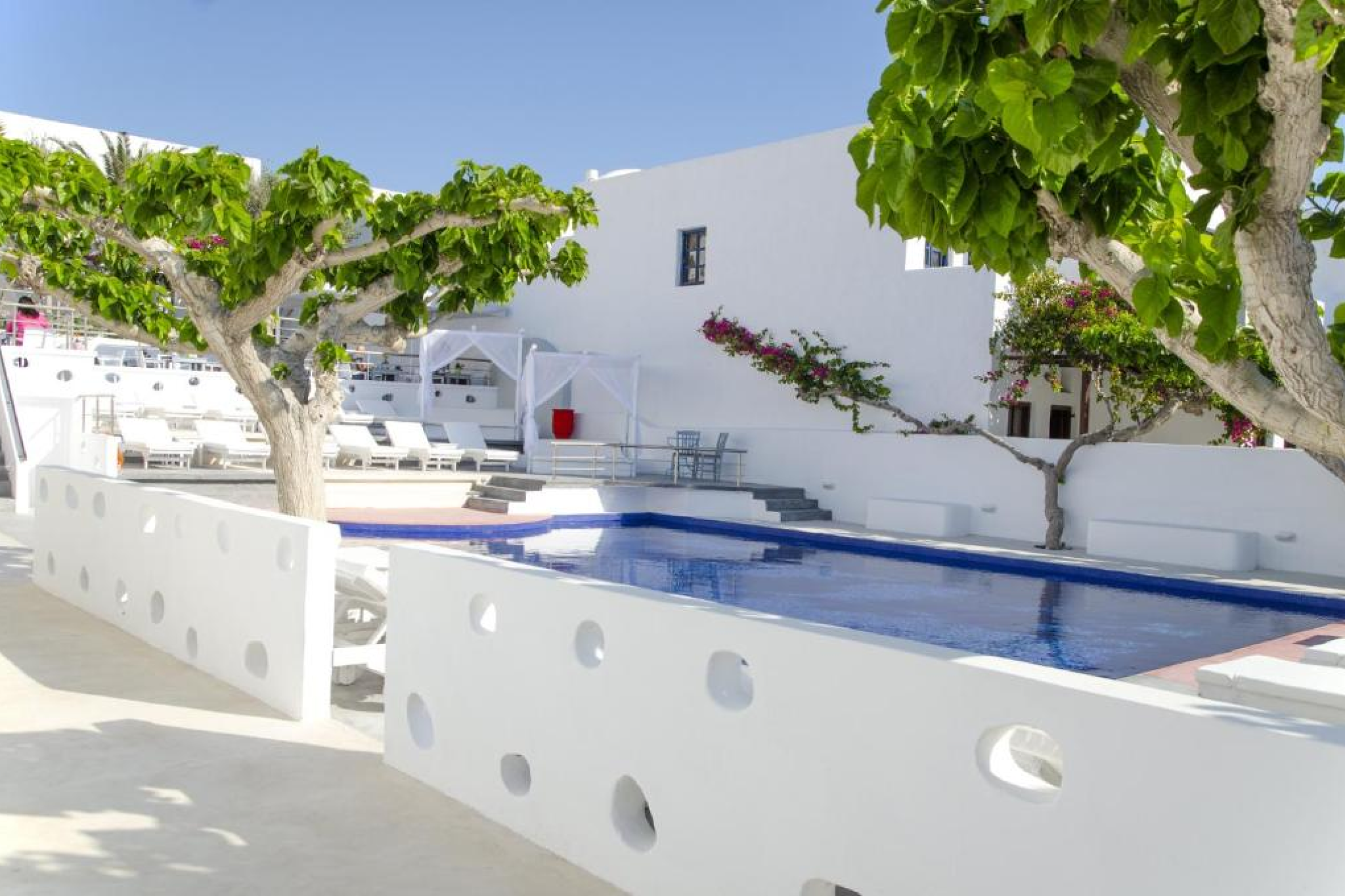 Poolside area of RK Beach Boutique Hotel in Kamari, among the Best Beach Resorts in Santorini, steps away from the promenade with beach views and cozy loungers.