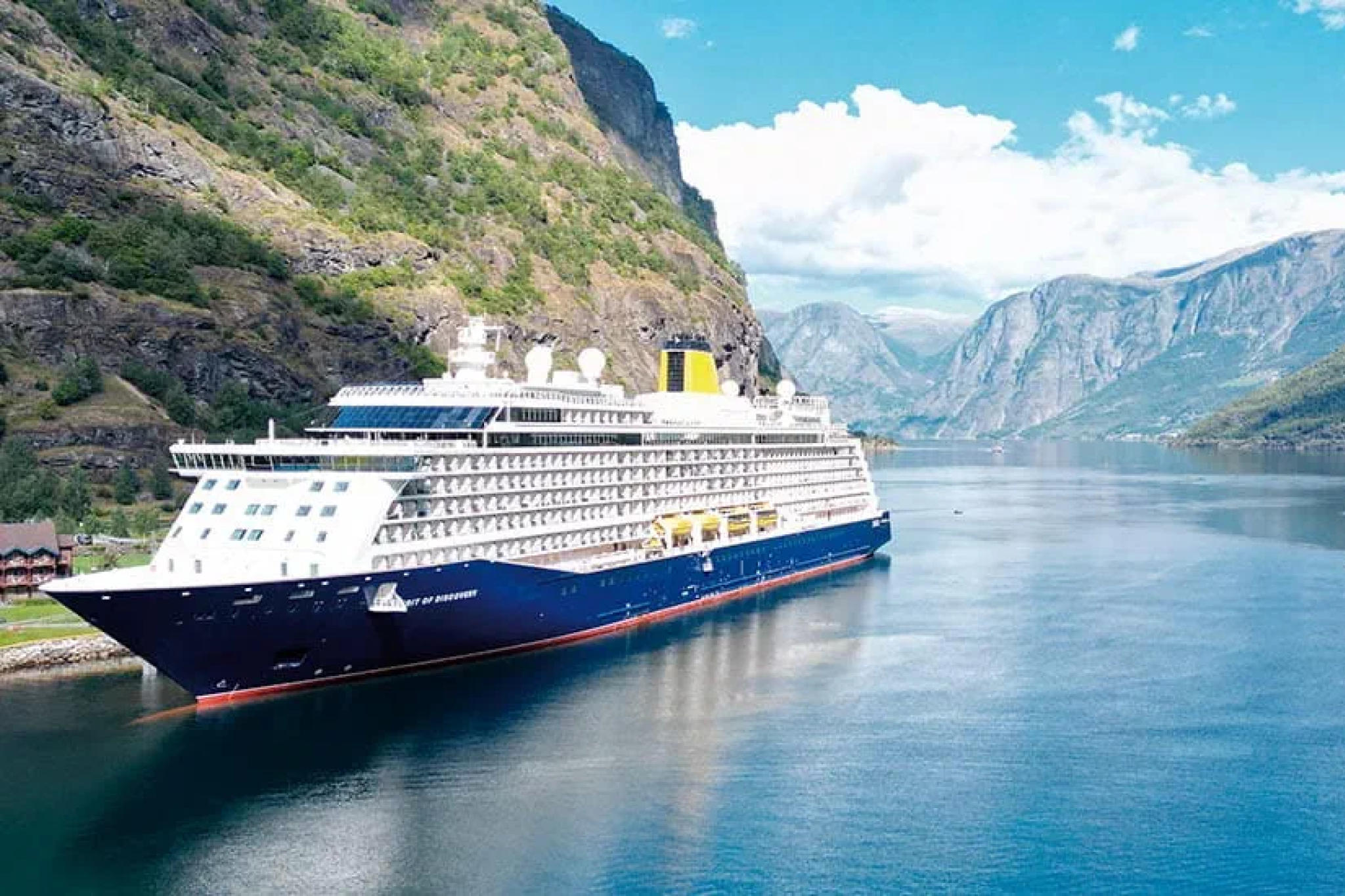 Saga Cruises ship sailing through scenic fjords, ranked 6th in the best adults-only cruises list for travelers over 50.