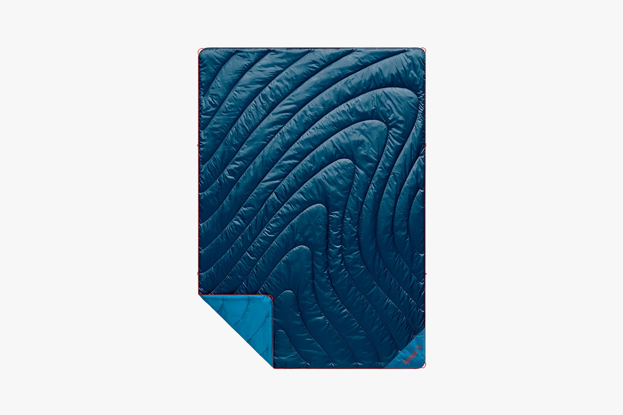 Rumpl Original Puffy blanket with quilted insulation and ocean wave pattern - one of the best beach blankets for warmth and packability