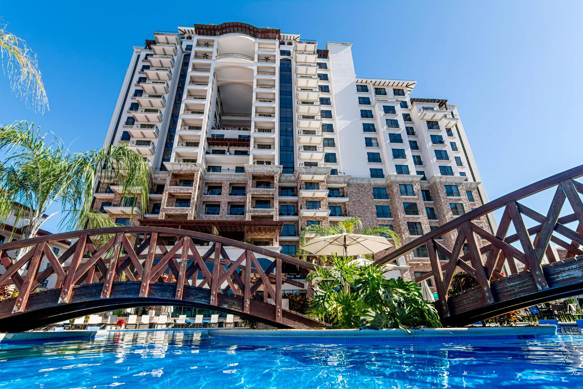 Resort pool with modern hotel tower backdrop at Crocs Resort & Casino in Jacó—one of the best beach hotels in Costa Rica for travelers who want full-scale entertainment and ocean proximity.
