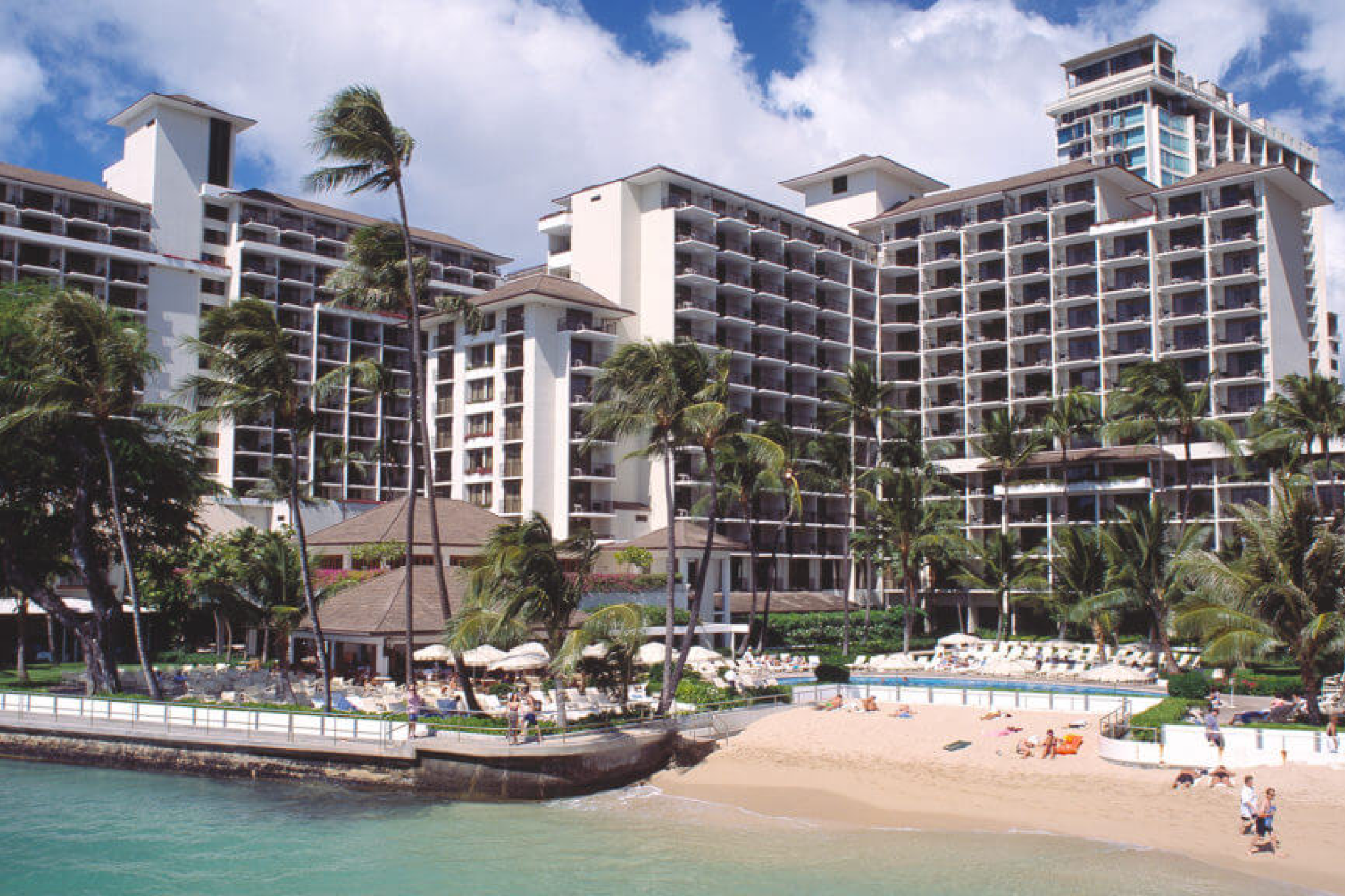 Beachfront view of Halekulani Hotel in Honolulu, Hawaii — a Pacific icon included in the best luxury beach resorts in the United States.