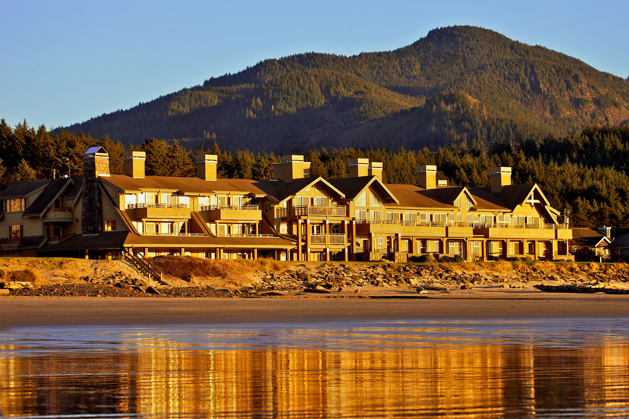 Oceanfront lodge with mountain backdrop at The Ocean Lodge in Oregon — a top example of the best luxury beach resorts in the United States.