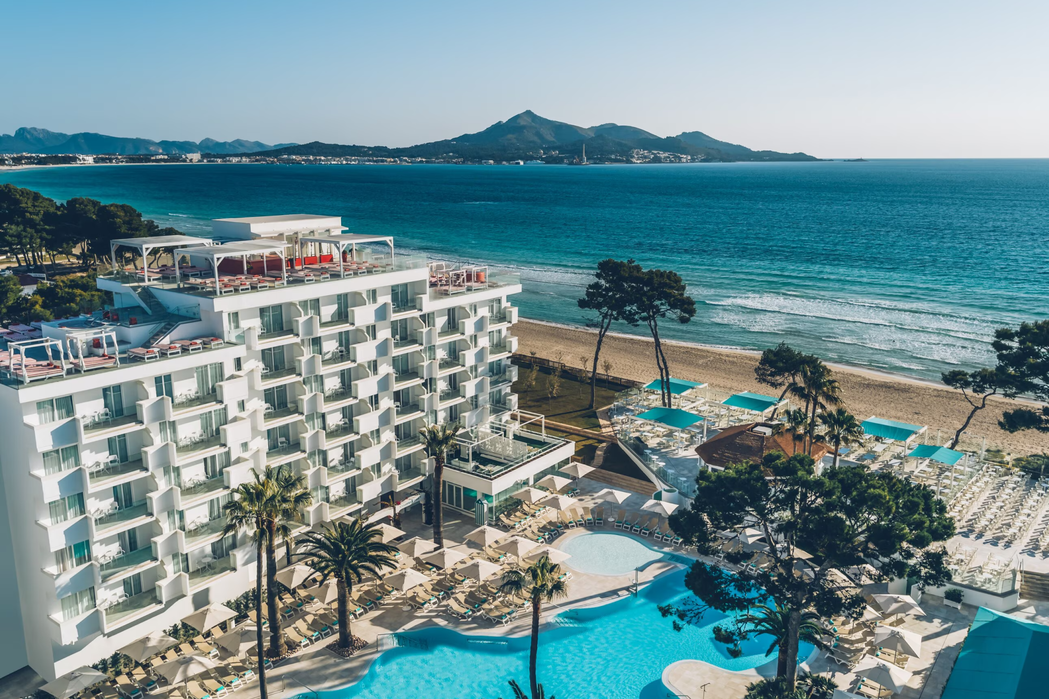 Cliffside view of Iberostar Selection Jardín del Sol Suites overlooking Santa Ponsa Bay, with tiered balconies and infinity pools — a standout among the best beach resorts in Mallorca for adults-only luxury.