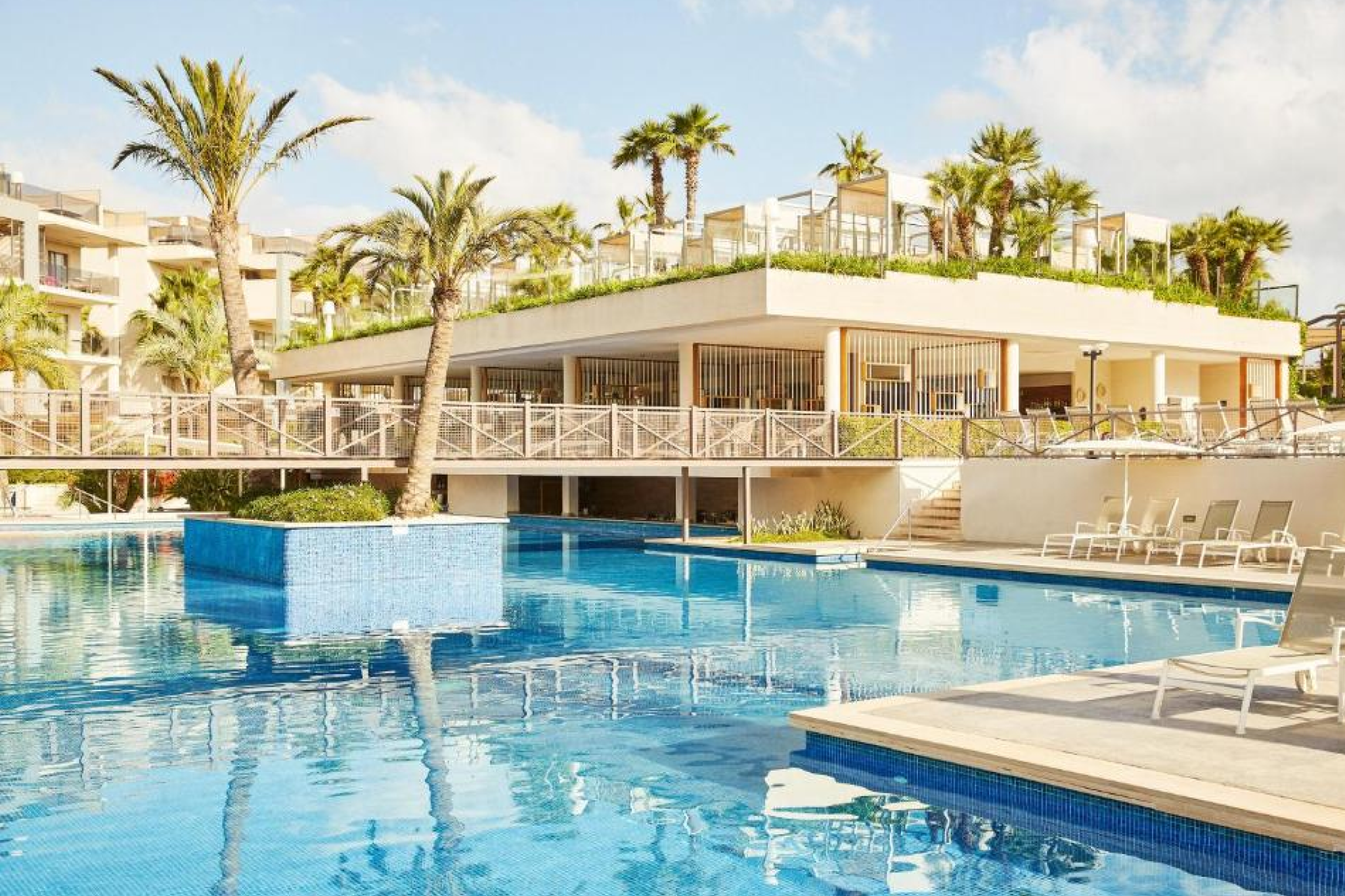 Iberostar Waves Ciudad Blanca resort right on Alcudia Bay with beachfront loungers, multiple pools, and a family-friendly vibe — among the best beach resorts in Mallorca for relaxed seaside stays.