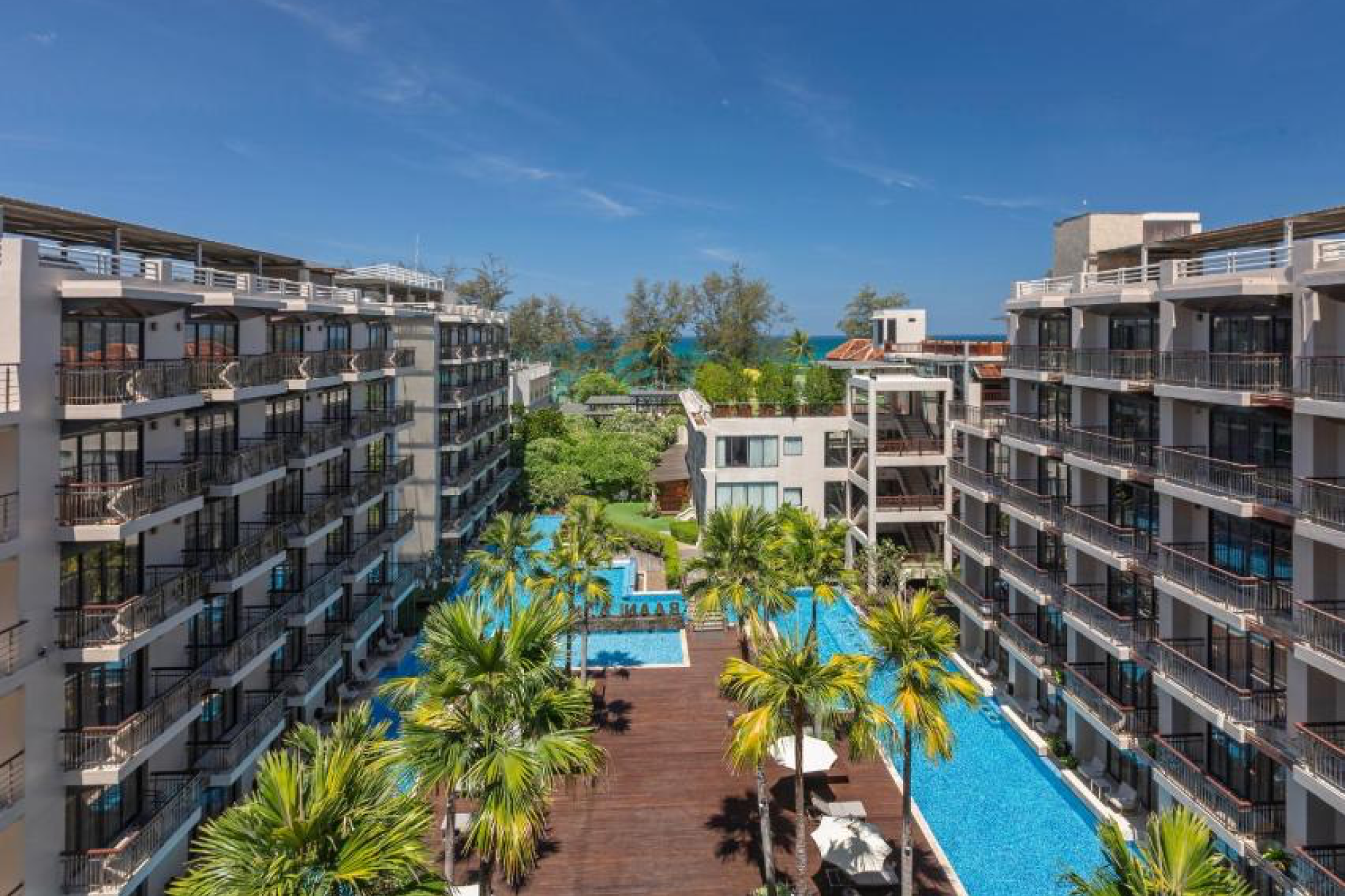 Baan Laimai Beach Resort & Spa in Patong with large pool, palm trees, and ocean views — one of the best beach resorts in Phuket.