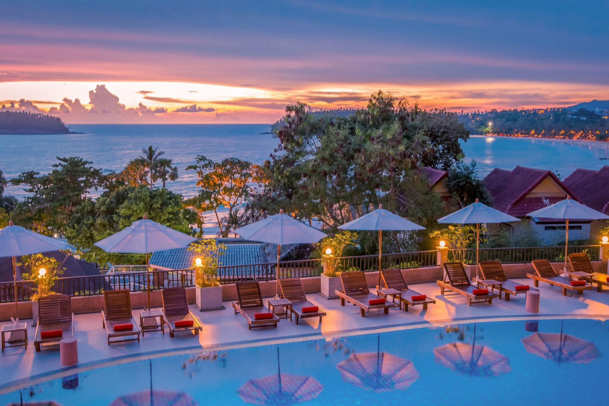 Sunset over Kata Beach from the pool terrace of Chanalai Garden Resort, a hillside retreat recognized as one of the best beach resorts in Phuket.