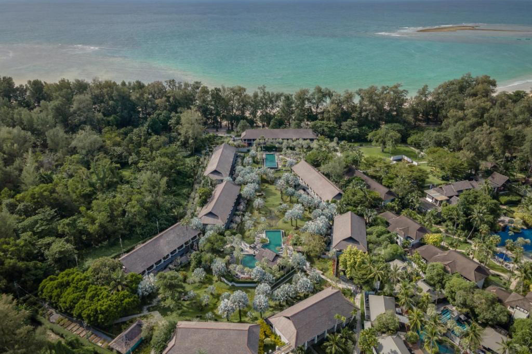 Design-forward The Slate Phuket with creative architecture, pools, and beachfront location — a unique contender for the best beach resorts in Phuket.