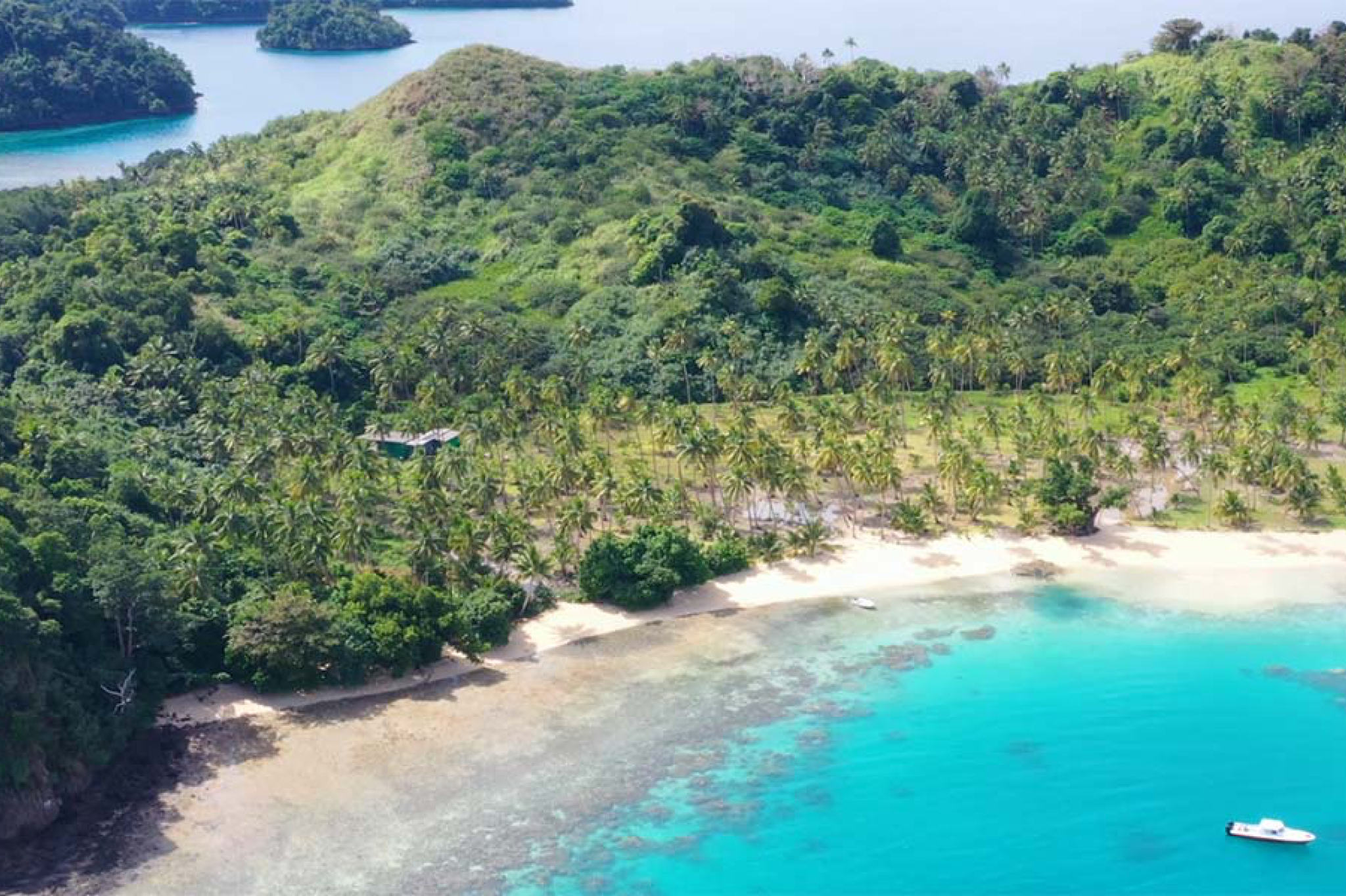 Aerial view of Vatuvara Private Islands with untouched coastline, coconut groves, and bright turquoise water, defining its exclusivity as one of the best beach resorts in the South Pacific in 2025.