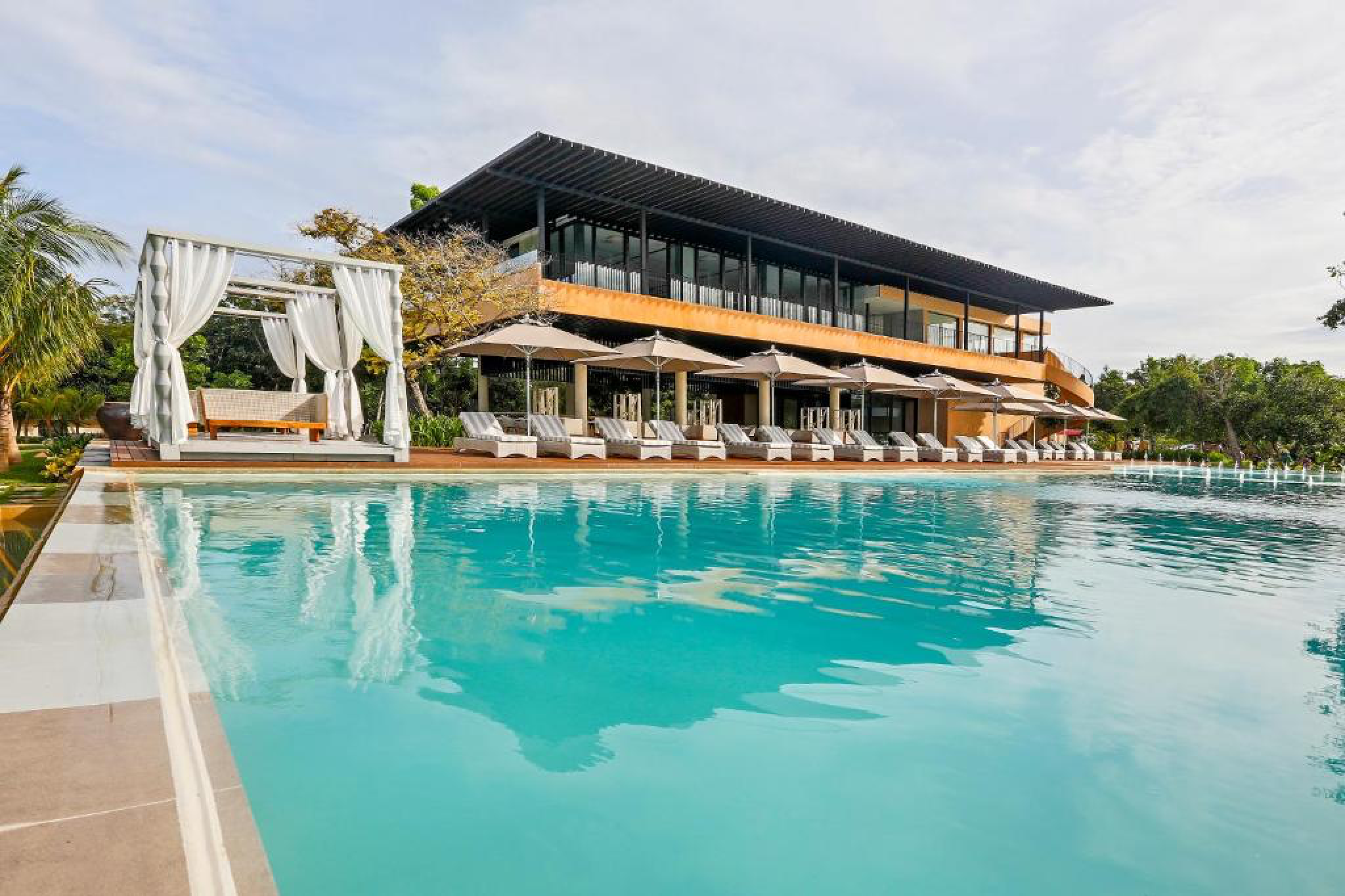 Infinity pool and modern suites at Amorita Resort on Panglao Island, listed among the best beach resorts in the Philippines.