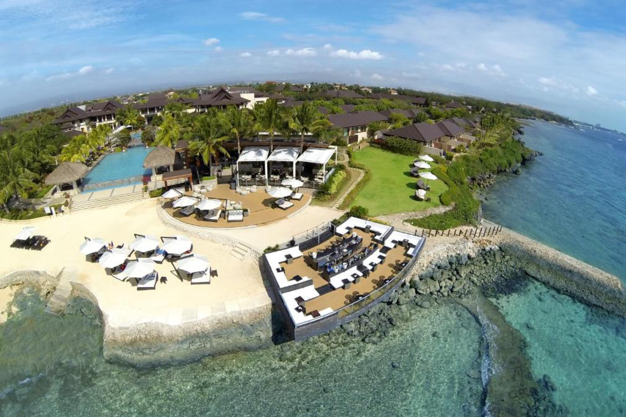 Aerial view of Crimson Resort Mactan with beachfront lounge and infinity pool, featured in the best beach resorts in the Philippines.