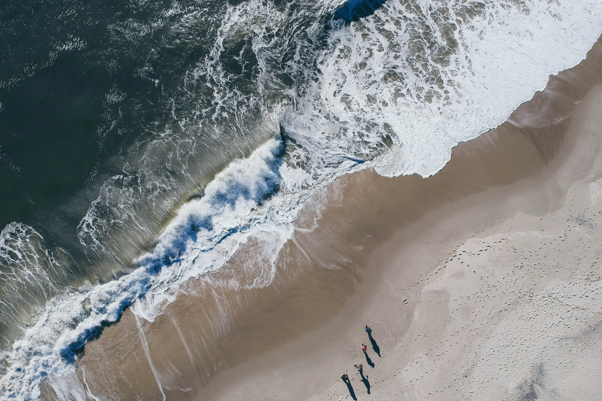 Aerial view of pristine Cape May Beach with visitors enjoying the calm Atlantic waters, highlighting why it's among the best beaches on the US East Coast