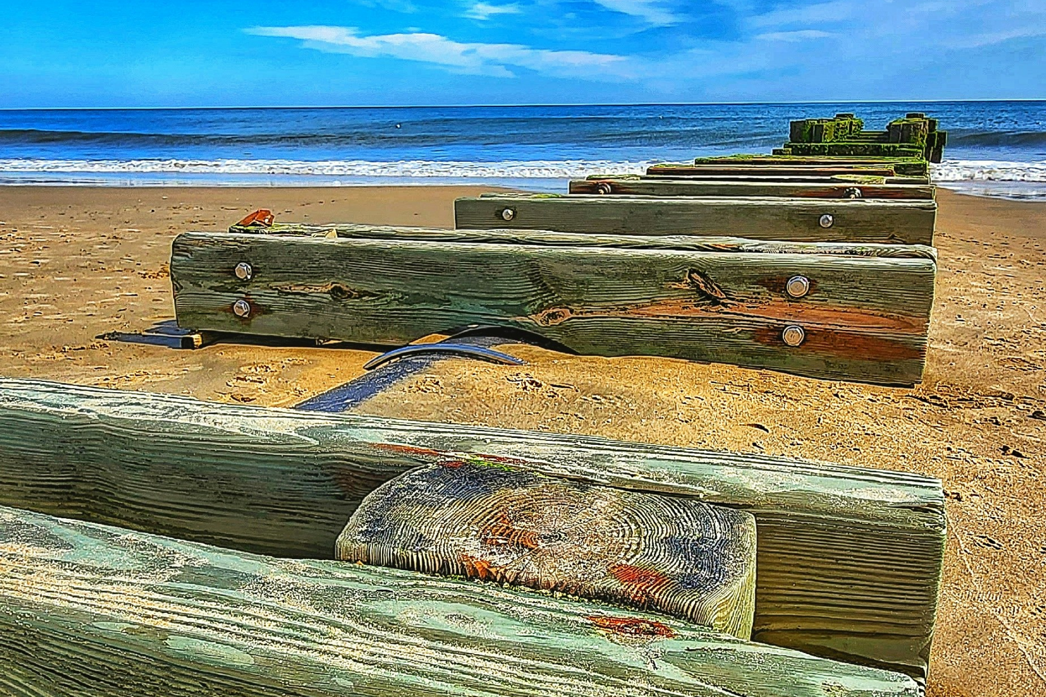 Weathered wooden groyne structures on Rehoboth Beach showcasing the classic coastal charm that makes it one of the best beaches on the US East Coast