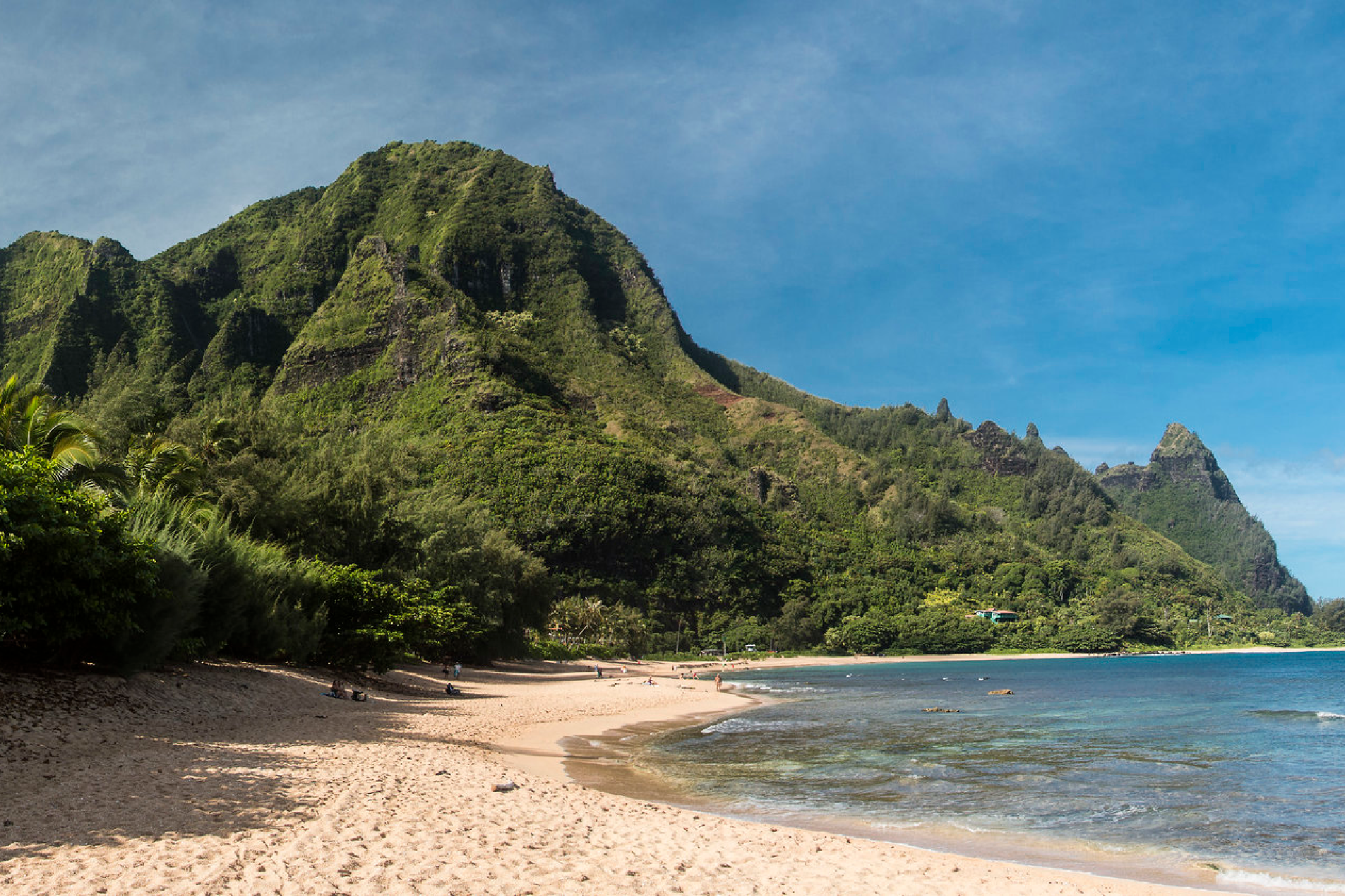 Ha‘ena Beach and the dramatic Na Pali cliffs rising behind—a snorkeler’s haven and one of the best beaches in Kauai for natural beauty and underwater exploration.