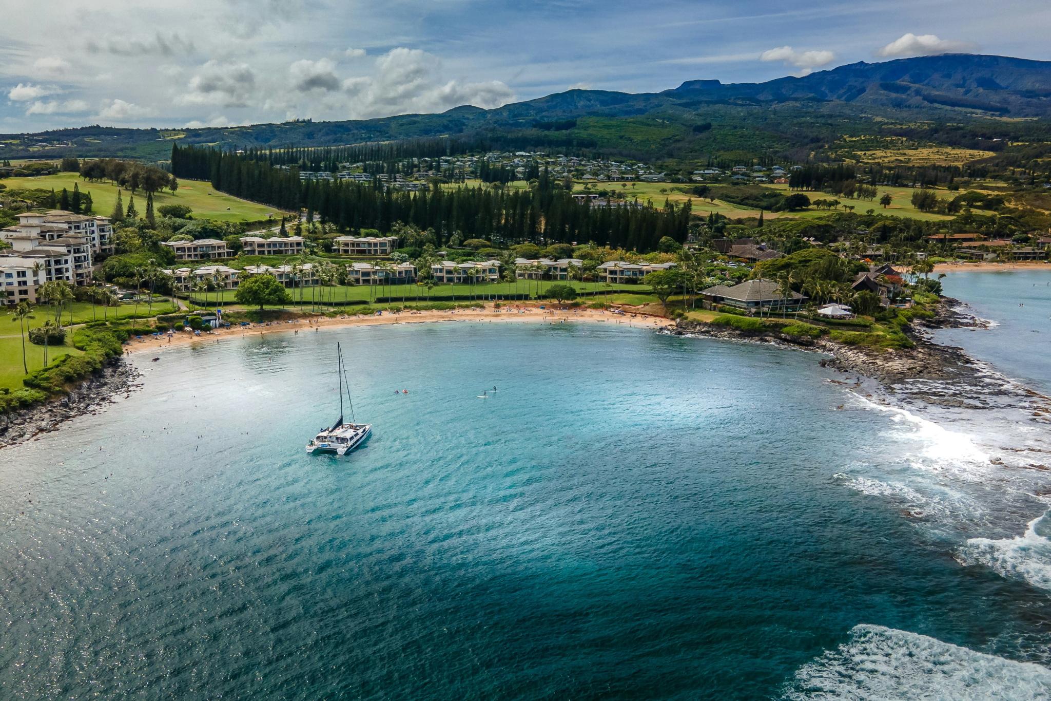 Aerial view of Kapalua Beach’s calm turquoise waters and sheltered crescent shore, celebrated as one of the best beaches in Maui for peaceful swimming and snorkeling.