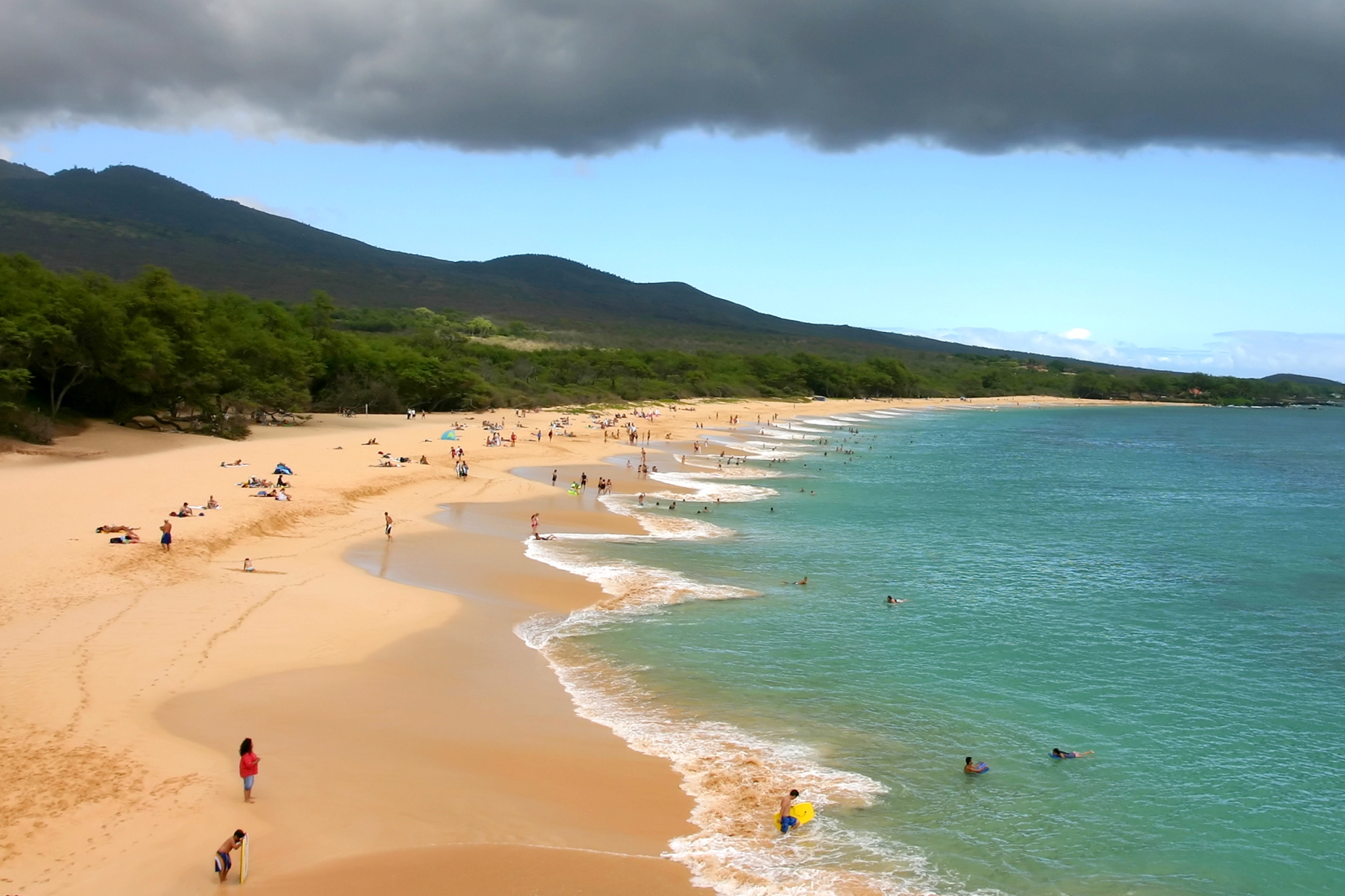A vast stretch of golden sand at Makena Beach, a nice beach in Maui prized for its natural beauty and wide shoreline.