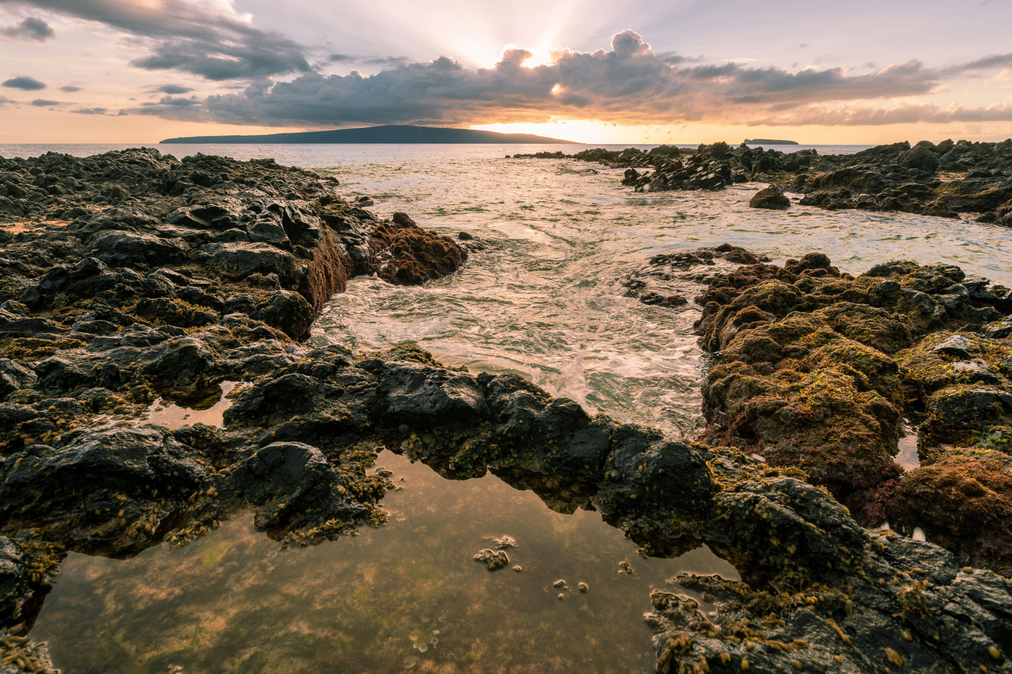 Secluded rocky shoreline and clear waters at Secret Cove, a hidden gem and one of the best beaches in Maui known for its peaceful and private atmosphere.