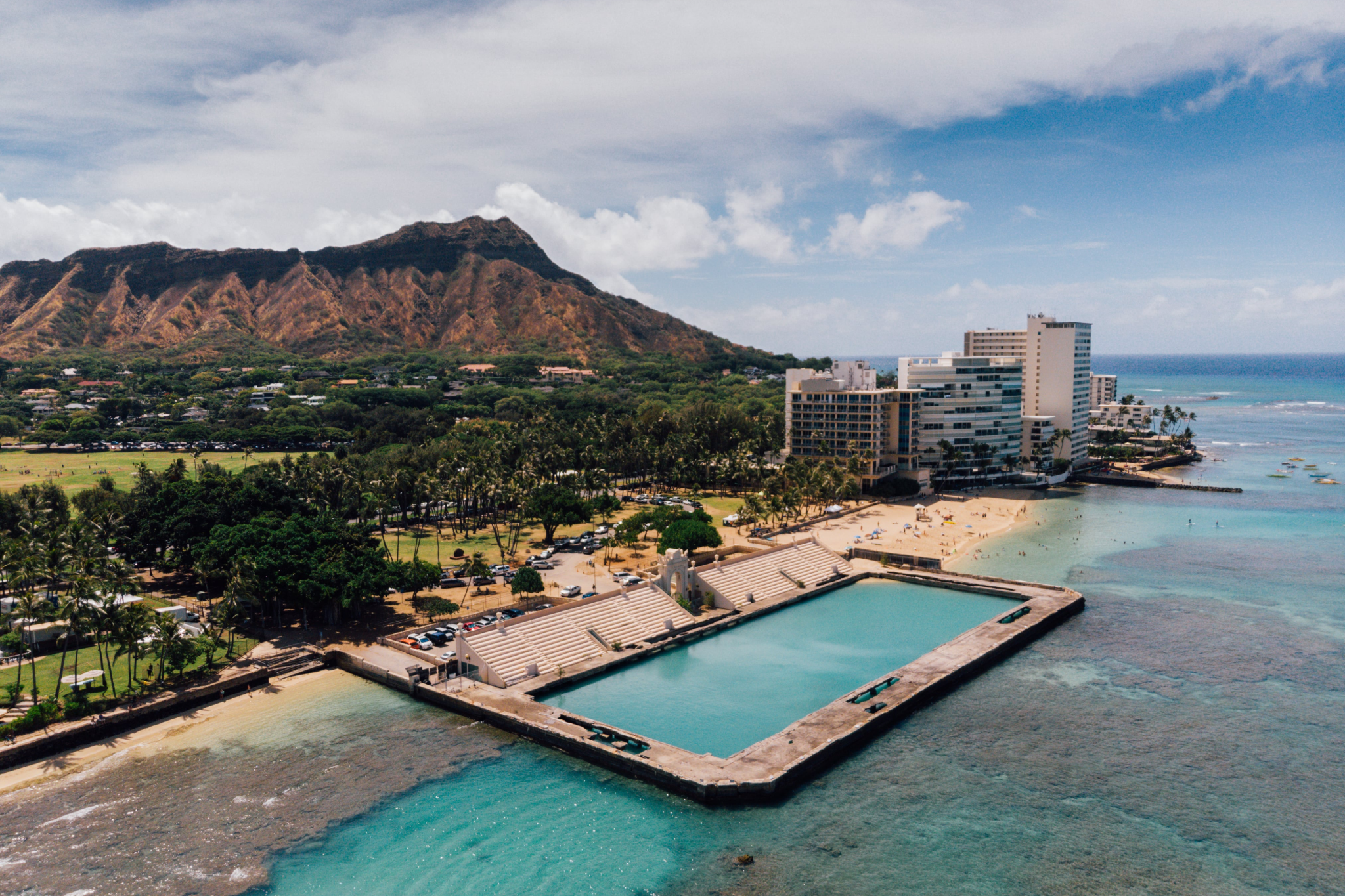 Alohilani Resort modern beachfront towers with Diamond Head mountain backdrop and ocean lagoon, contemporary best beachfront hotels in Waikiki