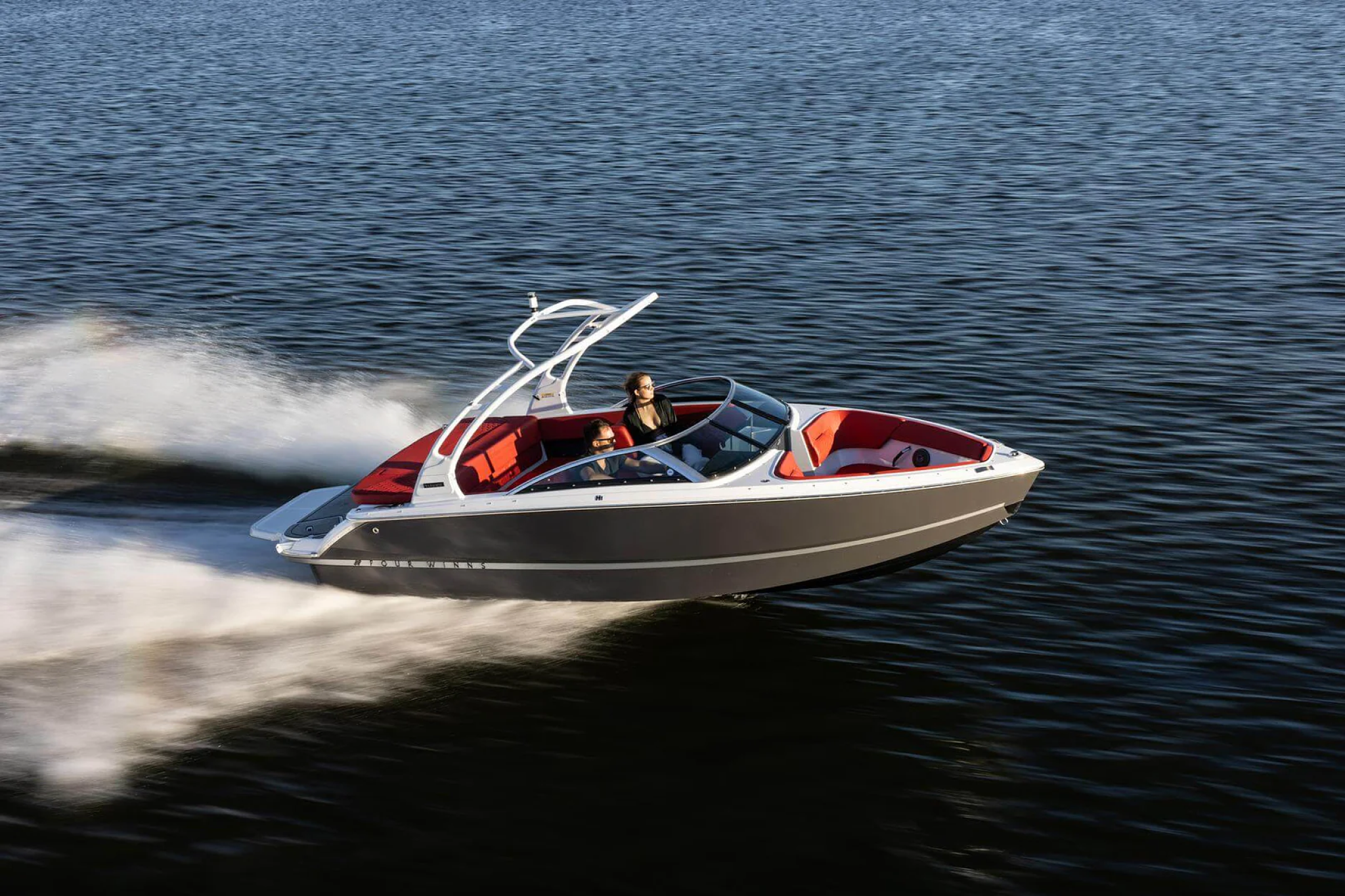 Four Winns H1 Freedom bowrider speeding across water, featured among the best boats for families for watersports