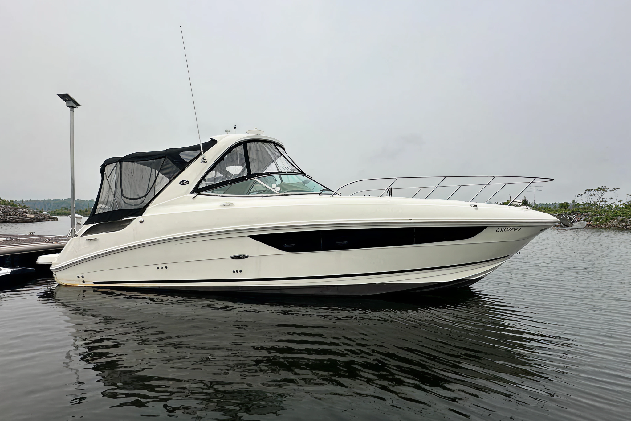Sea Ray 310 Sundancer cruiser moored at dock, considered one of the best boats for families for overnight trips