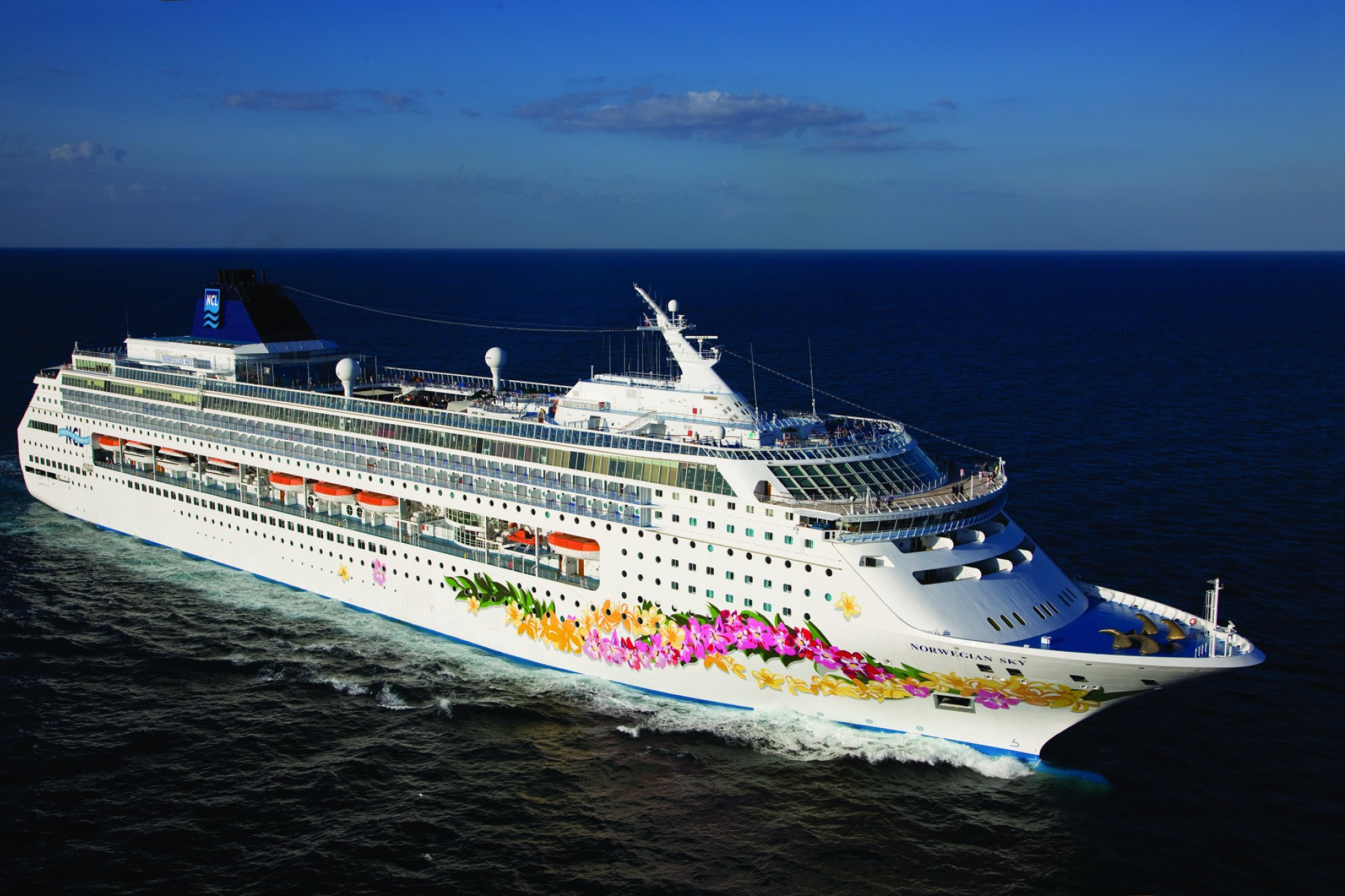 Norwegian Cruise Line ship with colorful hull art at sea, one of the best cruise lines for couples seeking flexible casual cruising