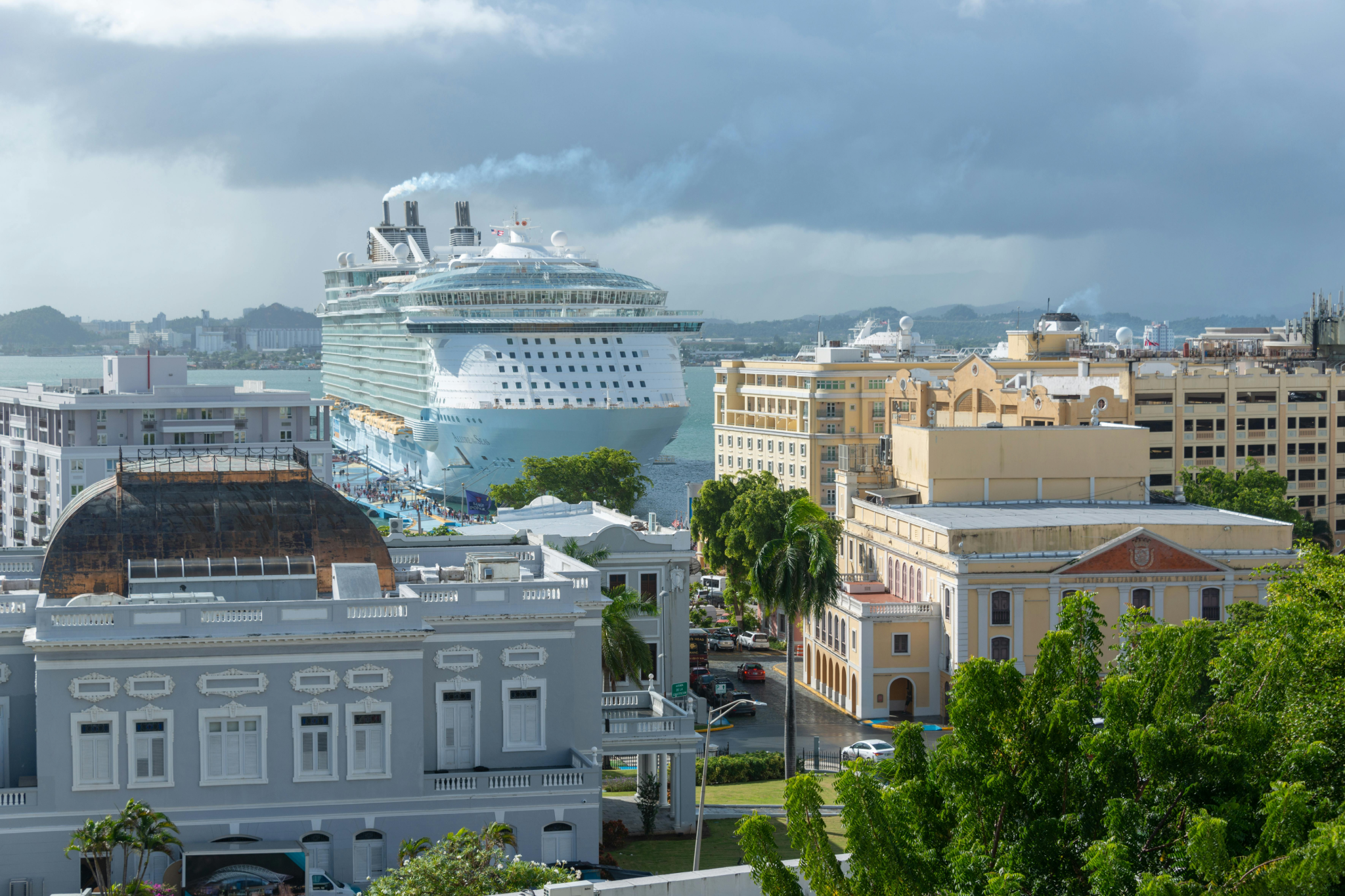 Cruise ship docked in San Juan harbor surrounded by colonial buildings and palm trees, highlighting the city’s colorful architecture and seamless port facilities, making it one of the best cruise ports in 2025.