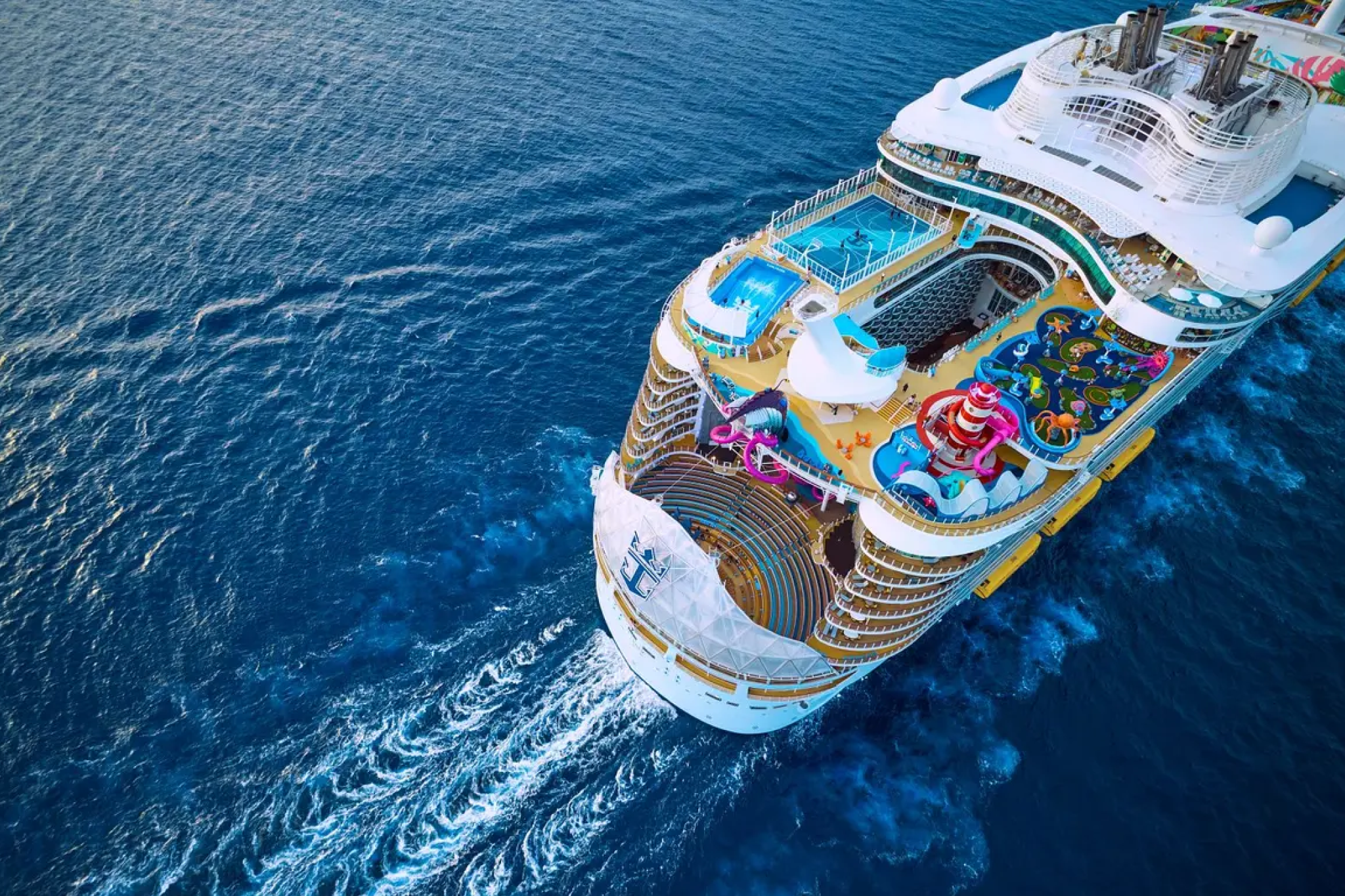 Aerial view of Royal Caribbean’s Oasis-class ship with water slides and pools, among the best cruises for Christmas in the Caribbean.
