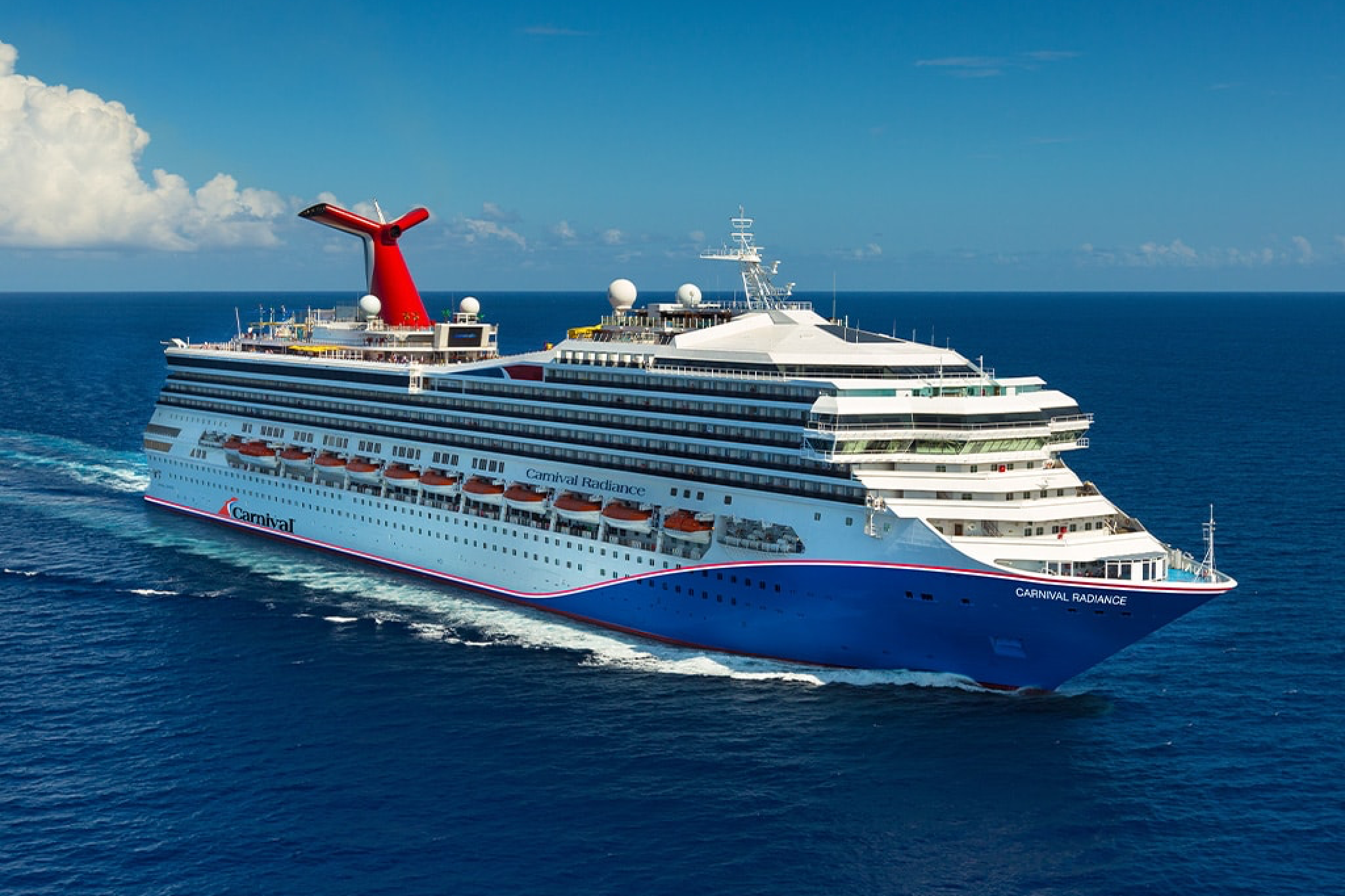 Carnival Cruise Line ship cruising through the Caribbean, featuring waterslides, family pools, and casual dining — among the Best Cruises for Families.
