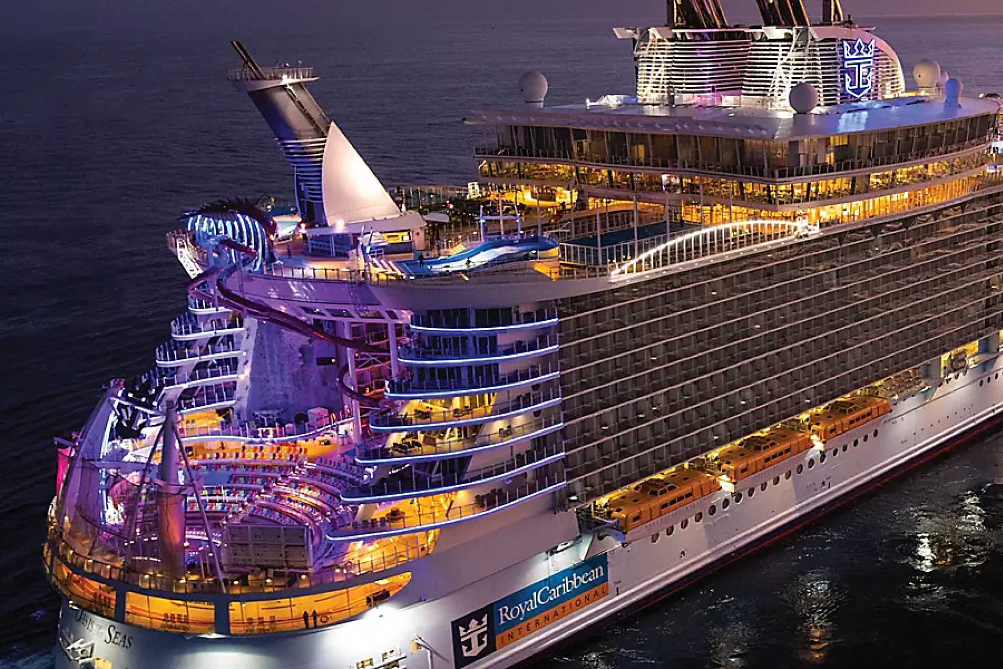 Royal Caribbean ship illuminated at night with lively decks and entertainment venues, symbolizing adventure and excitement aboard one of the Best Cruises for Honeymoon couples who enjoy vibrant nightlife and activities.