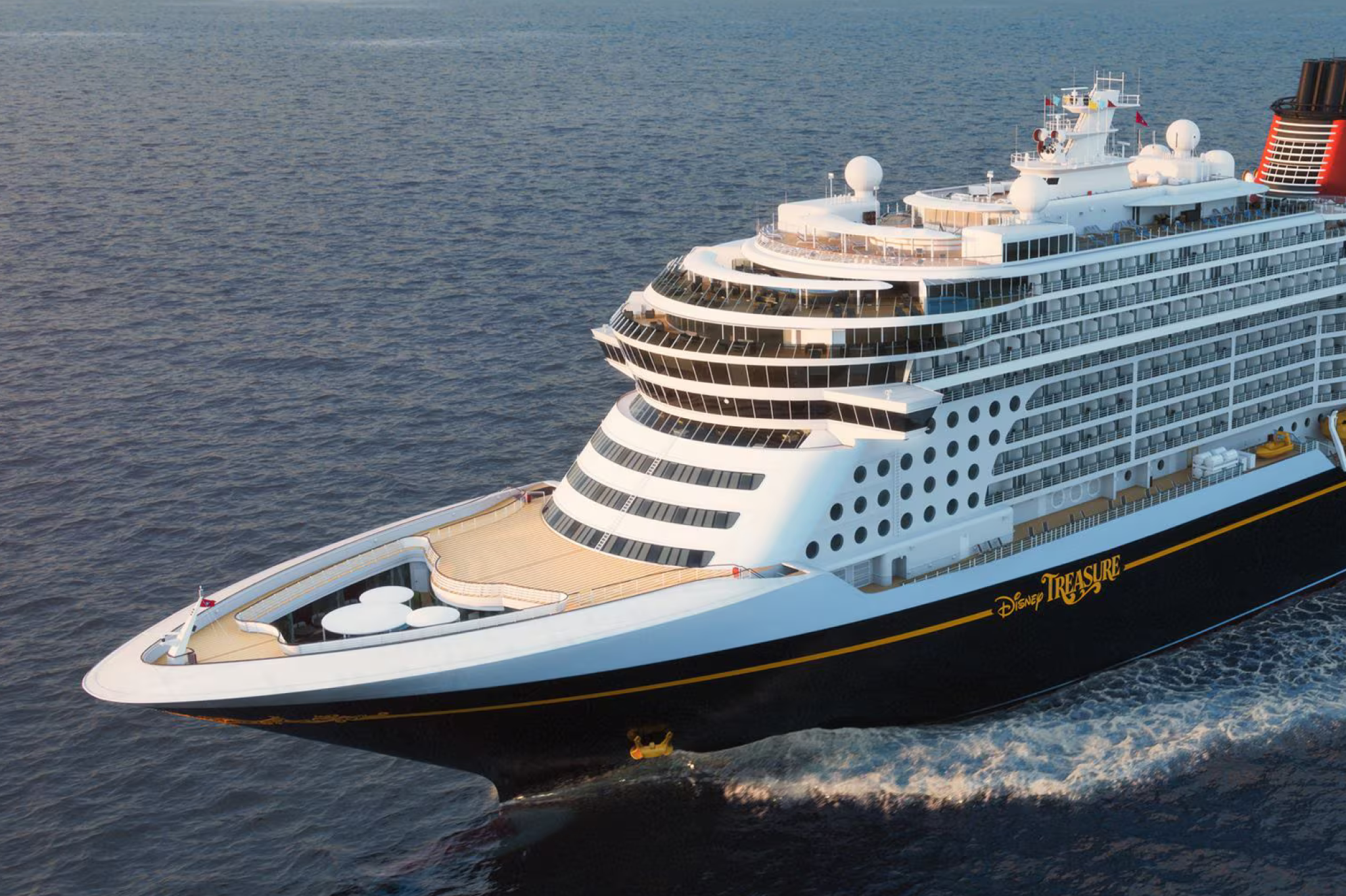 Disney Treasure cruise ship sailing at sea, highlighting why Disney is included among the best cruises for teens with its Vibe club and private island activities.