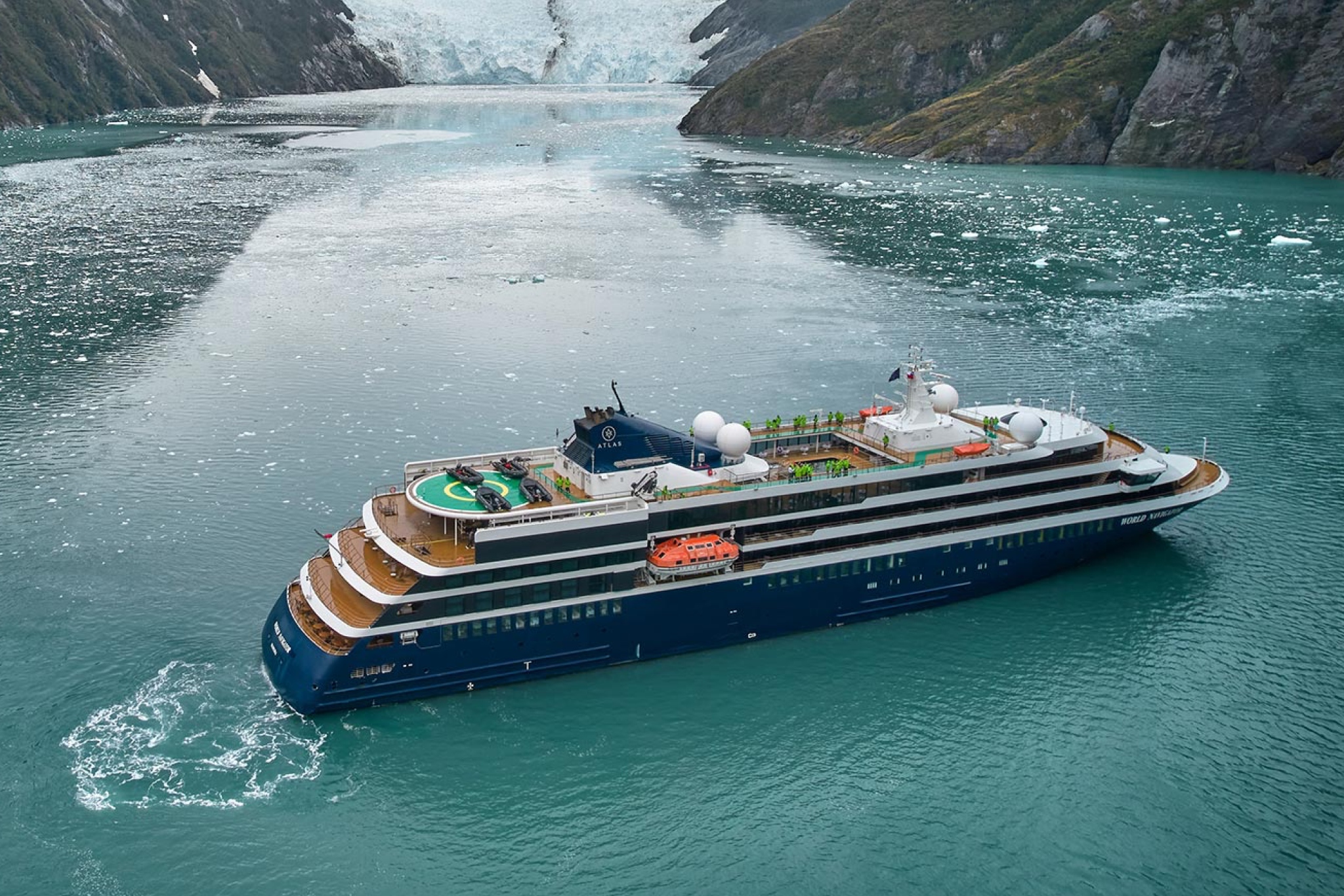 Atlas Ocean Voyages’ World Navigator gliding past glaciers, illustrating the yacht-style intimacy that defines the best expedition cruise lines.