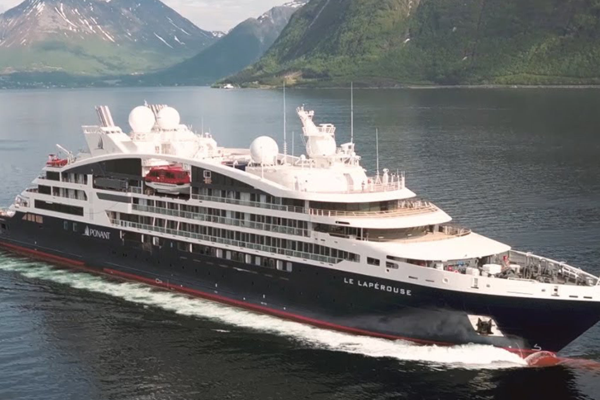 Ponant’s sleek Le Lapérouse expedition yacht cruising through a Norwegian fjord, an elegant example of the best expedition cruise lines blending style and discovery.