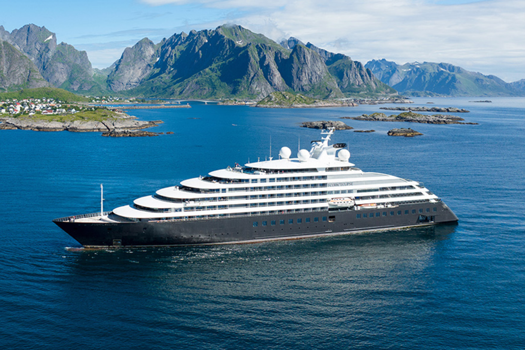Scenic Eclipse superyacht navigating along dramatic coastal peaks, representing the best expedition cruise lines at the ultra-luxury end of exploration travel.