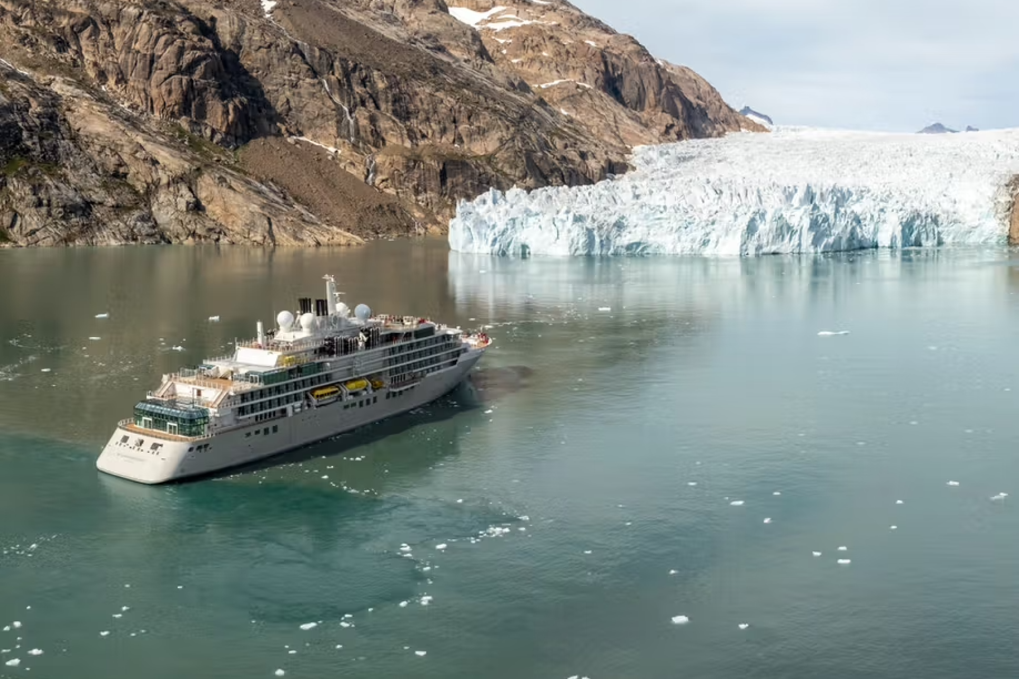 Silversea Expeditions ship sailing past a glacier in Greenland, showcasing why it ranks among the best expedition cruise lines for polar luxury and exploration.