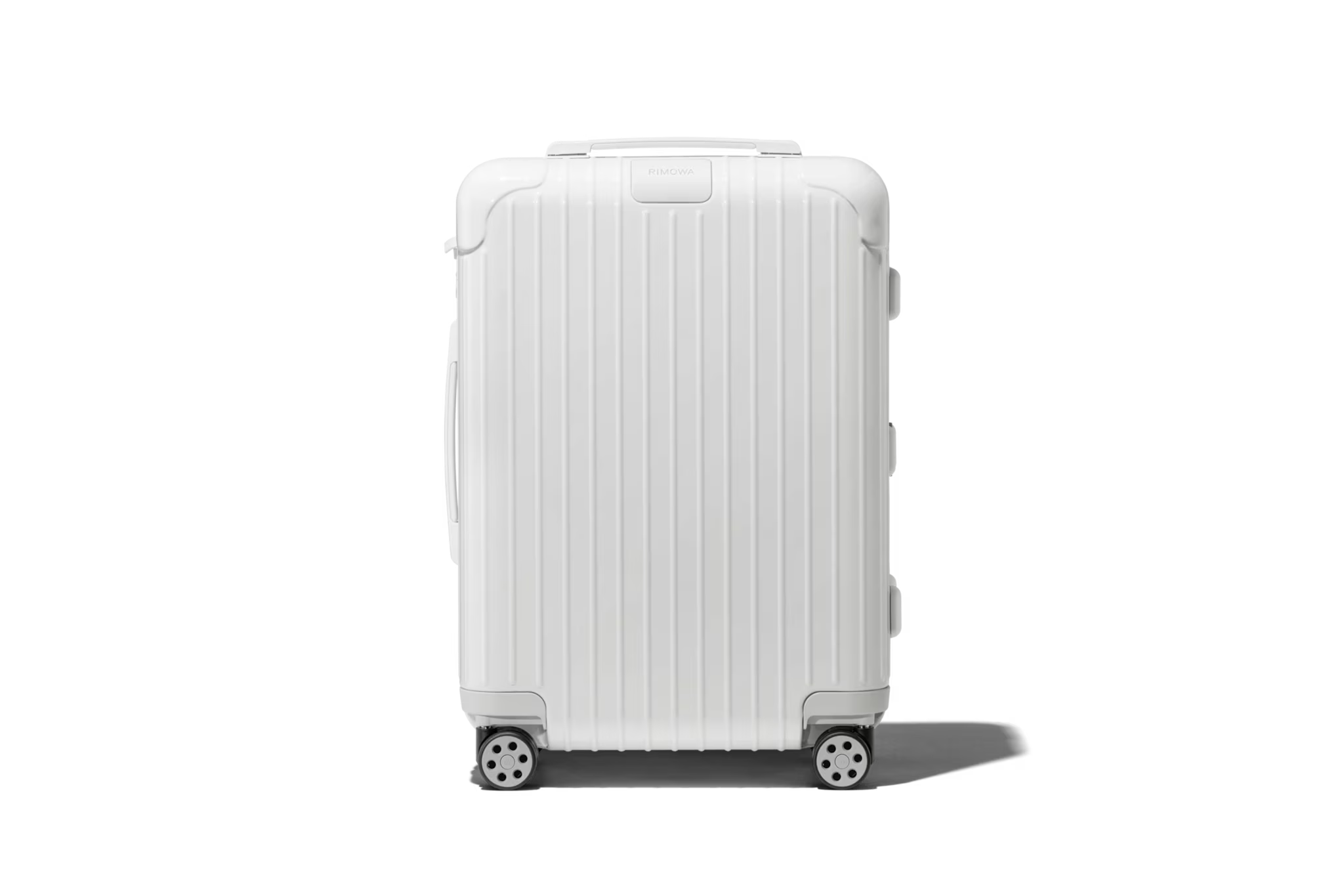 RIMOWA Essential Cabin S in white with signature grooved aluminum shell, one of the best luggages for travelers seeking luxury-grade hard-shell protection.