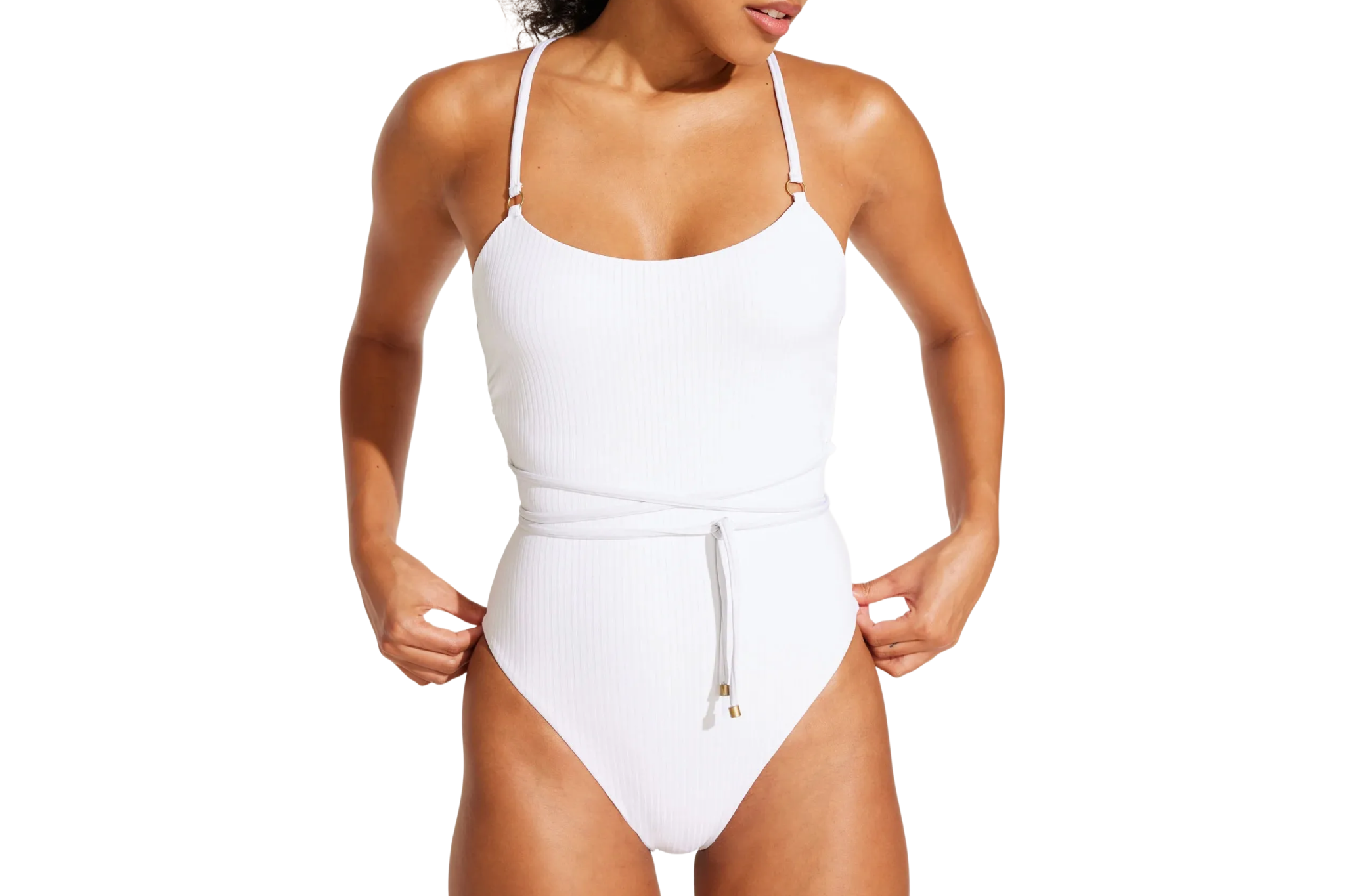 Model in a white Vitamin A Yara Wrap One-Piece Swimsuit with ribbed texture and wrap-tie waist, made from recycled materials – a sustainable favorite among the best one-piece swimsuits available.