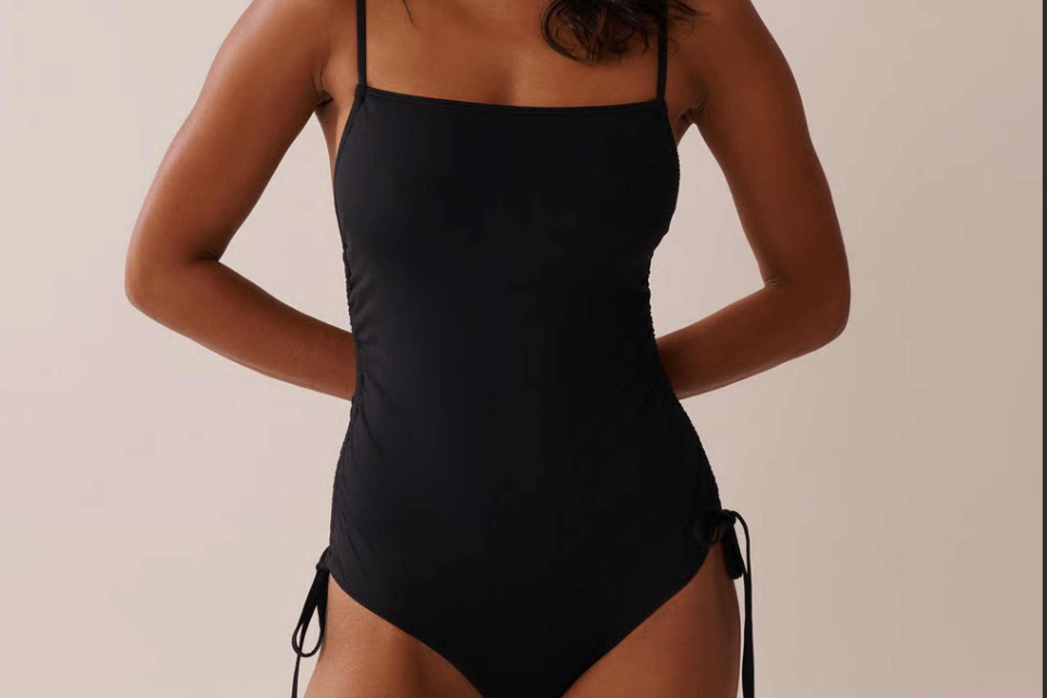 Front view of the La Vie en Rose Recycled One-Piece Swimsuit in black, featuring ruched sides and spaghetti straps – praised as one of the best one-piece swimsuits for comfort and stretch.