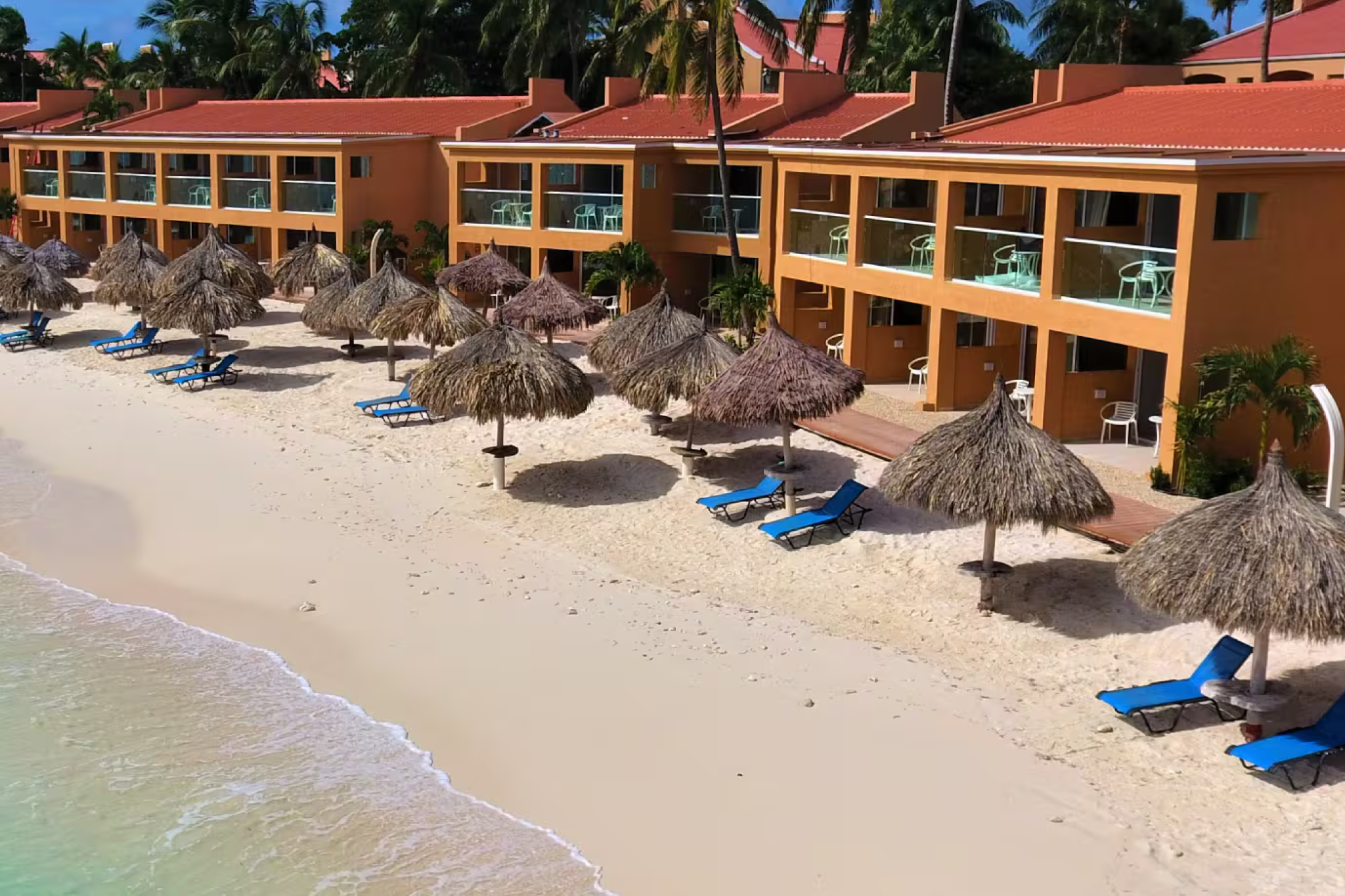 Tamarijn Aruba All Inclusive, one of the best resorts in Aruba, featuring beachfront rooms with thatched palapas and direct access to white sands and turquoise waters.