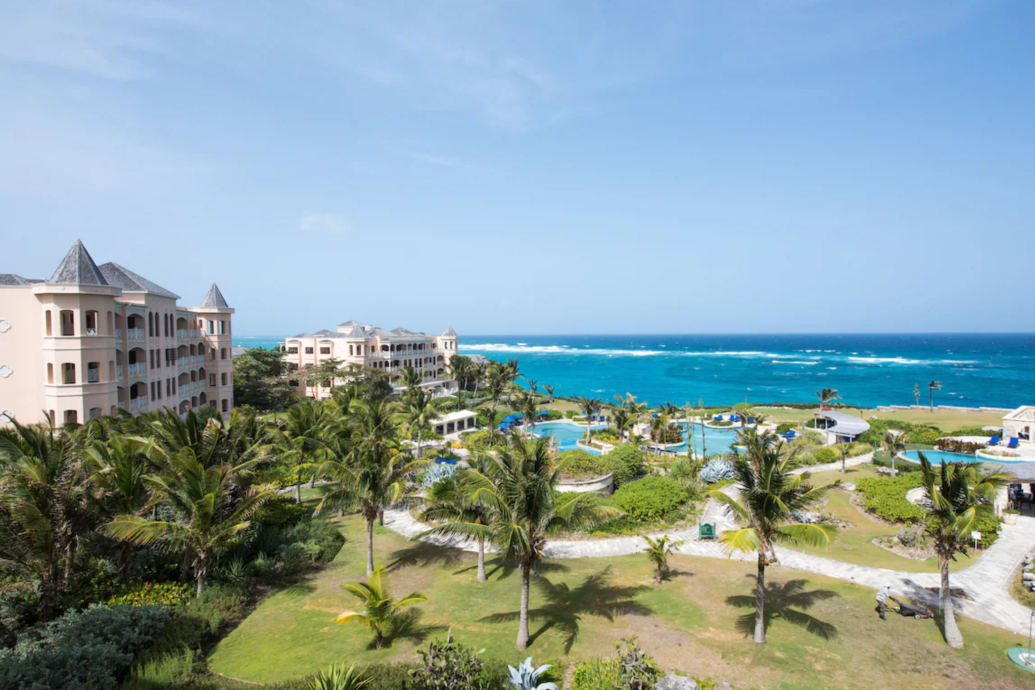 Clifftop view of The Crane Resort overlooking turquoise waters and lush gardens, a historic landmark among the best luxury resorts in Barbados.